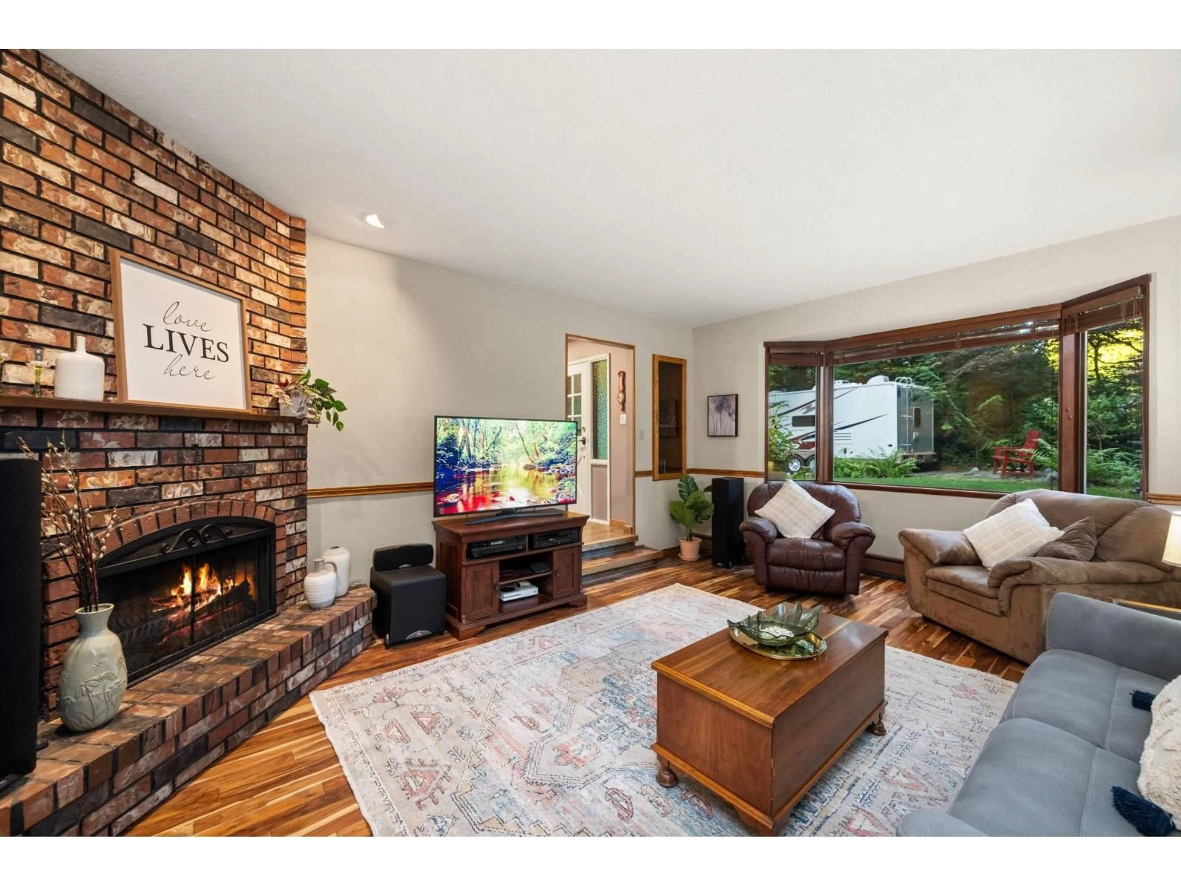 Living room with furniture, wood/laminate floor for 4961 202A, Langley British Columbia V3A1T6