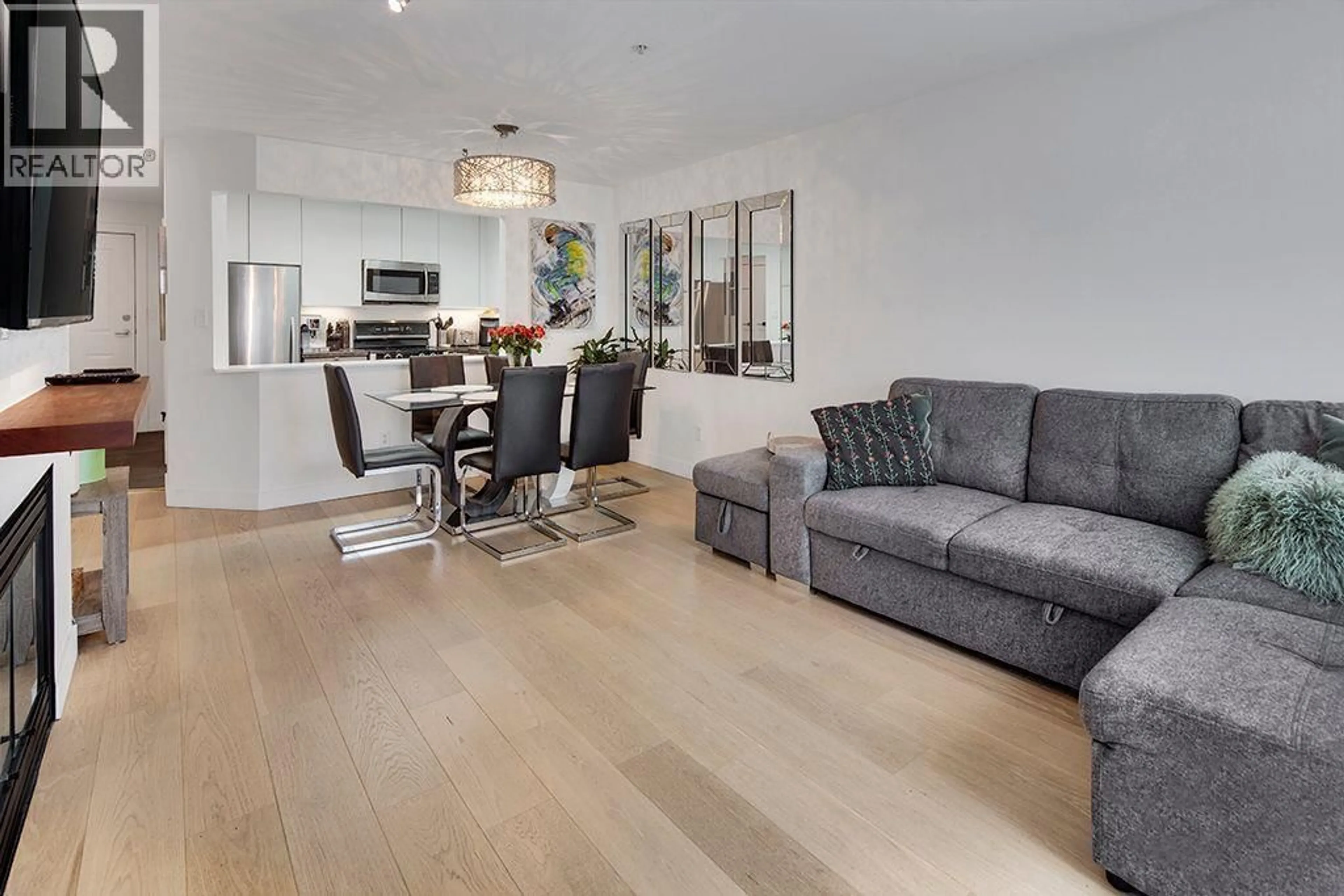 Living room with furniture, wood/laminate floor for 411 - 108 ESPLANADE AVENUE, North Vancouver British Columbia V7M3M8