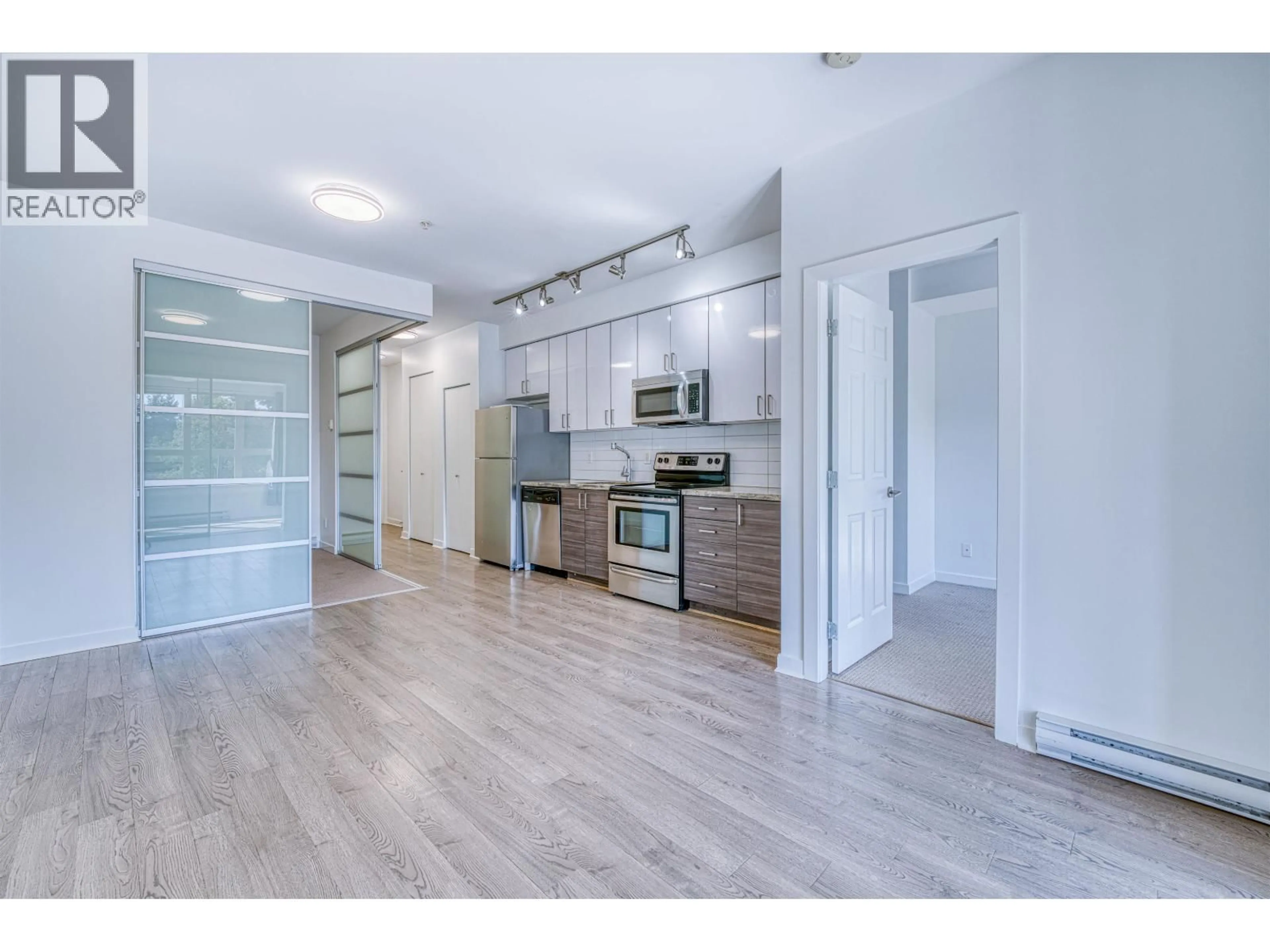 Open concept kitchen, wood/laminate floor for 308 - 3688 INVERNESS STREET, Vancouver British Columbia V5V0C5