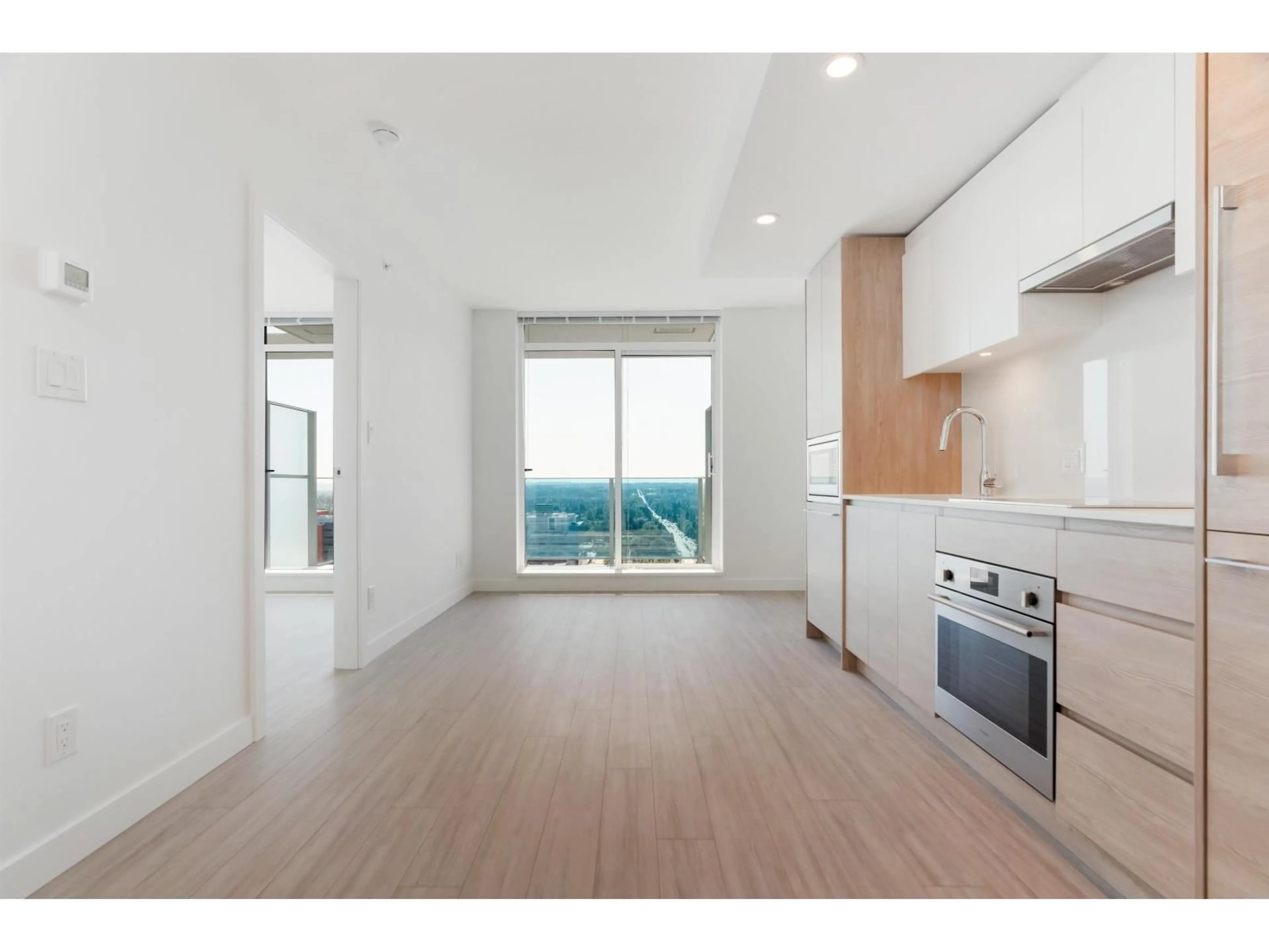 Open concept kitchen, wood/laminate floor for 2301 - 13615 FRASER, Surrey British Columbia V3T0P7