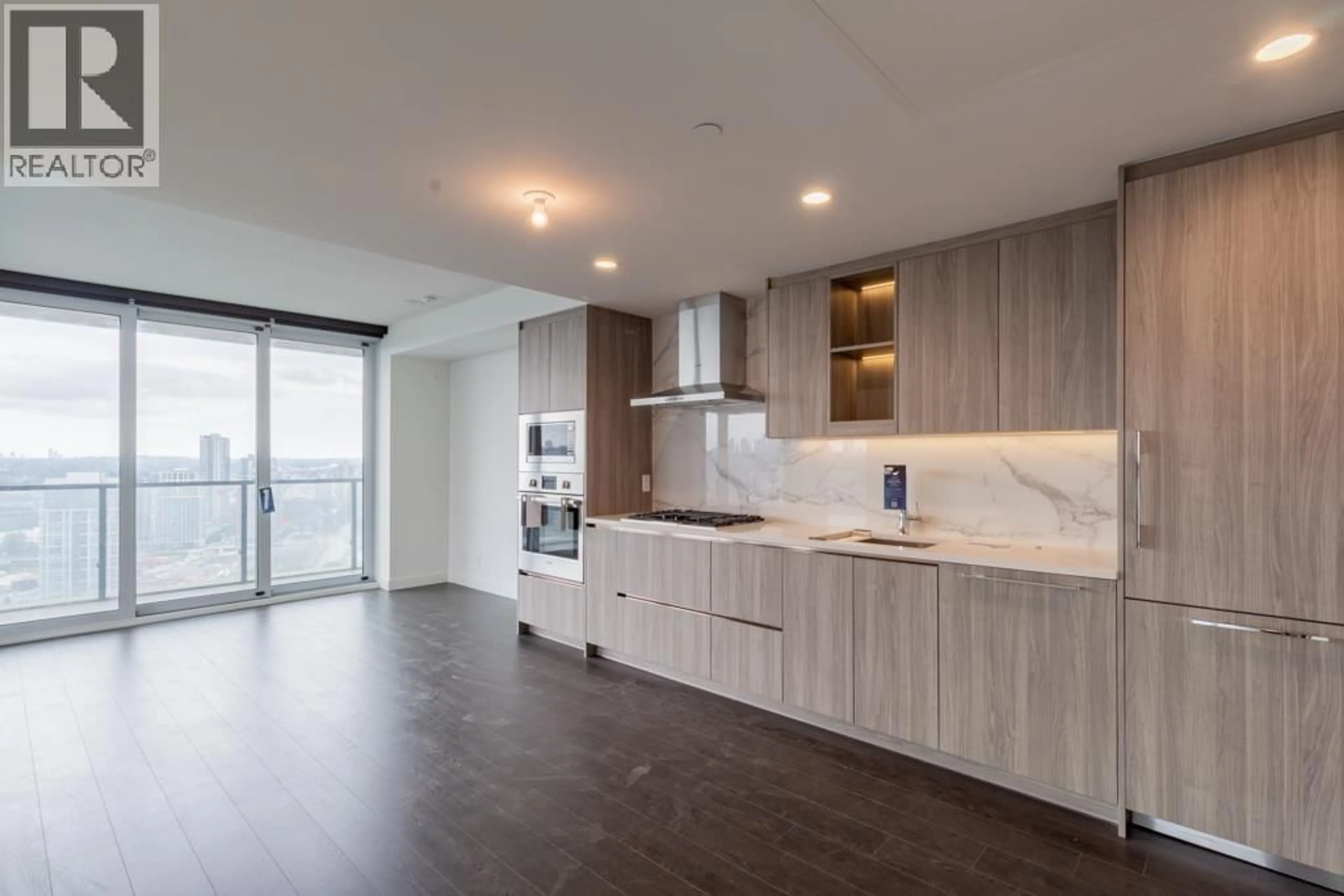 Open concept kitchen, wood/laminate floor for 2409 - 4880 LOUGHEED HIGHWAY, Burnaby British Columbia V5C0N1