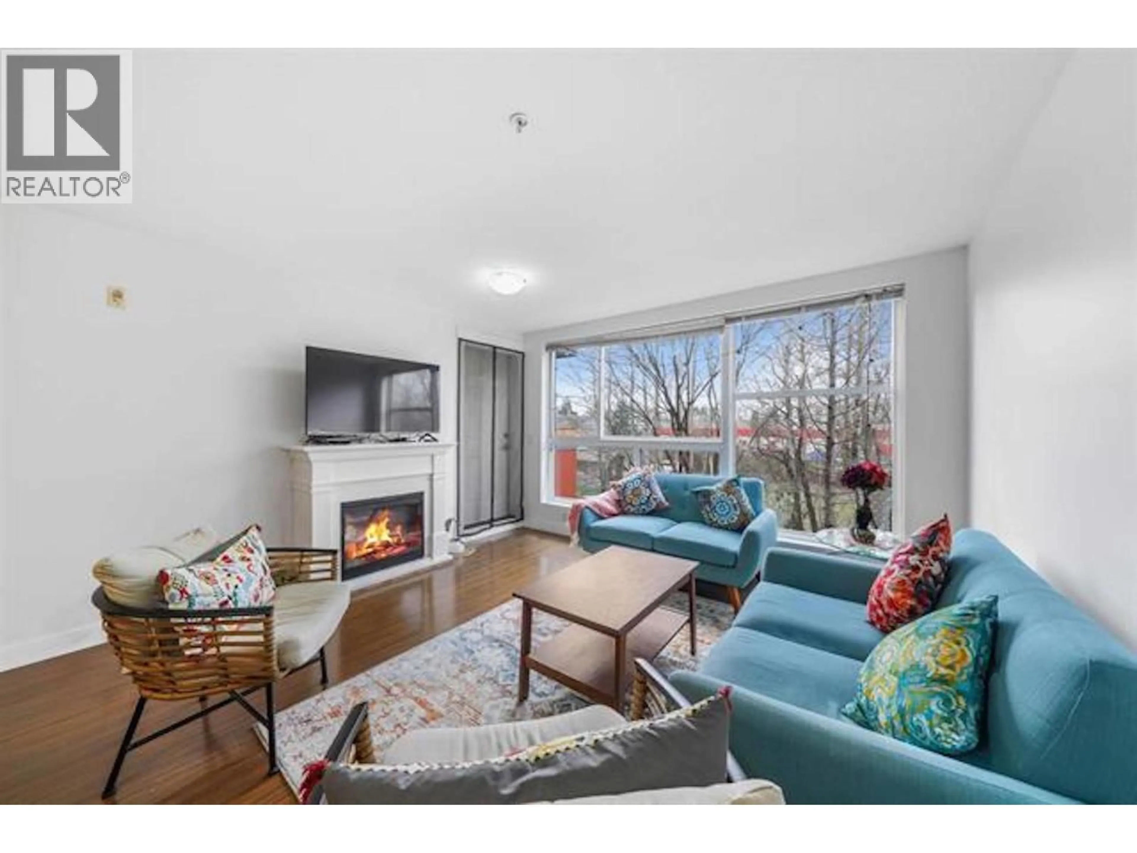 Living room with furniture, wood/laminate floor for 204 - 12075 228 STREET, Maple Ridge British Columbia V2X6M2