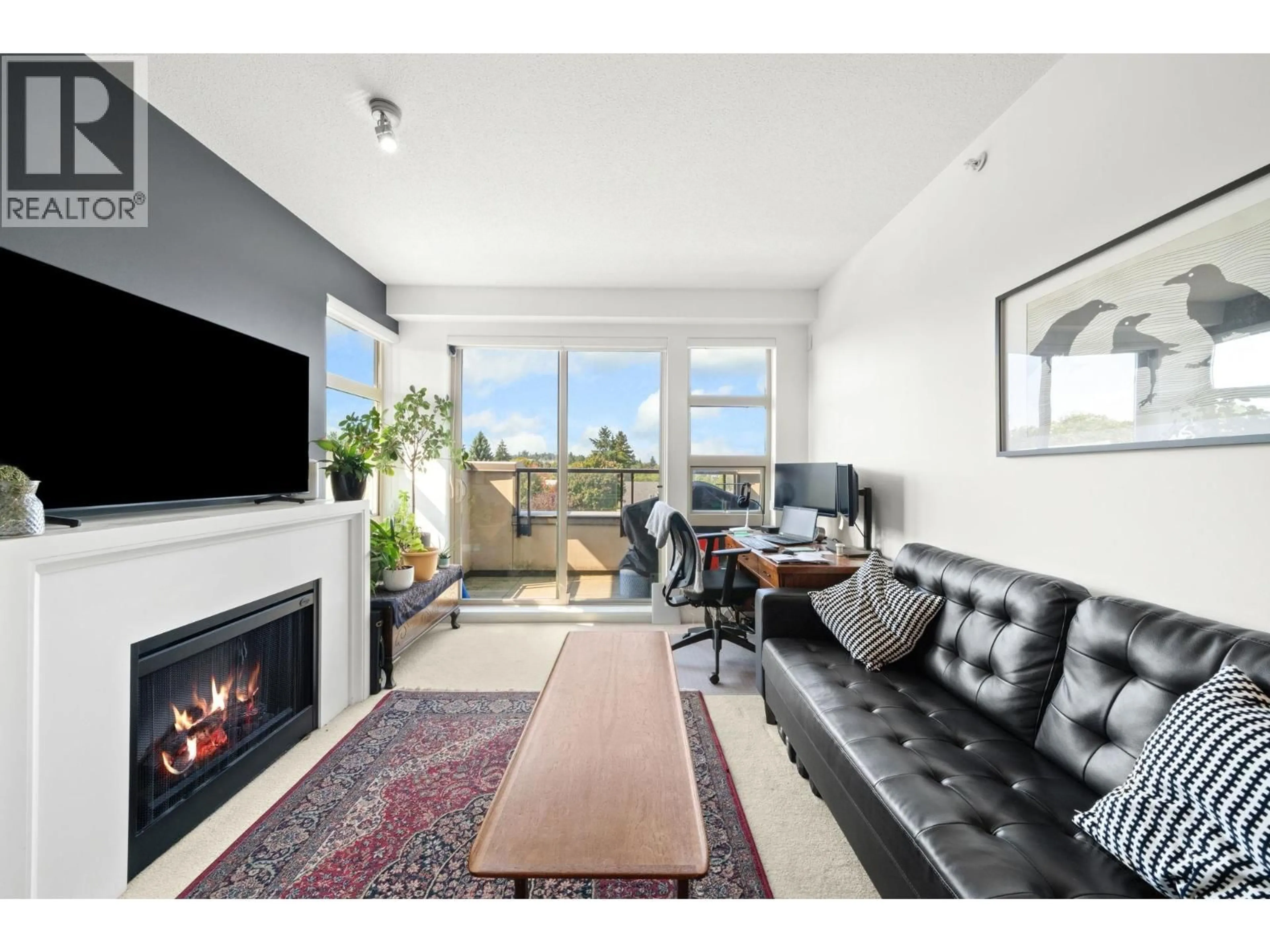 Living room with furniture, wood/laminate floor for 424 - 4550 FRASER STREET, Vancouver British Columbia V5V4G8