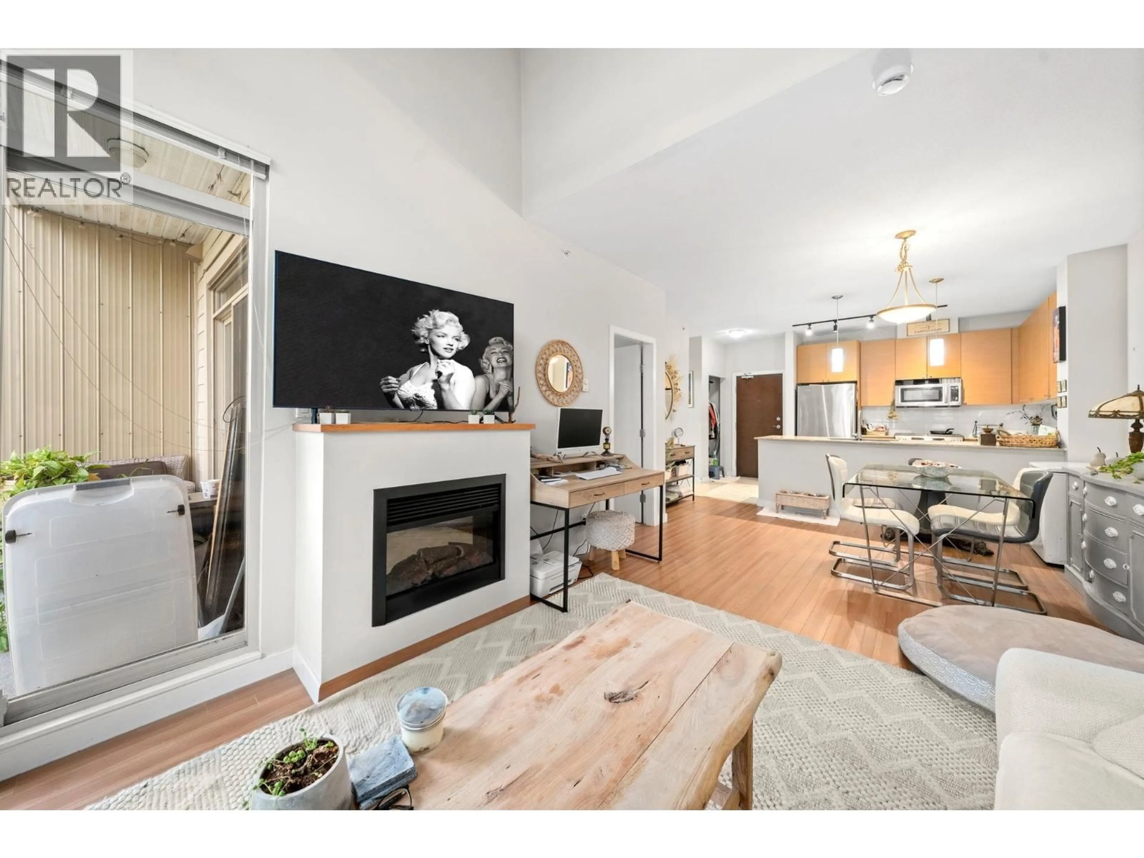 Living room with furniture, wood/laminate floor for 411 - 201 MORRISSEY ROAD, Port Moody British Columbia V3H0E5