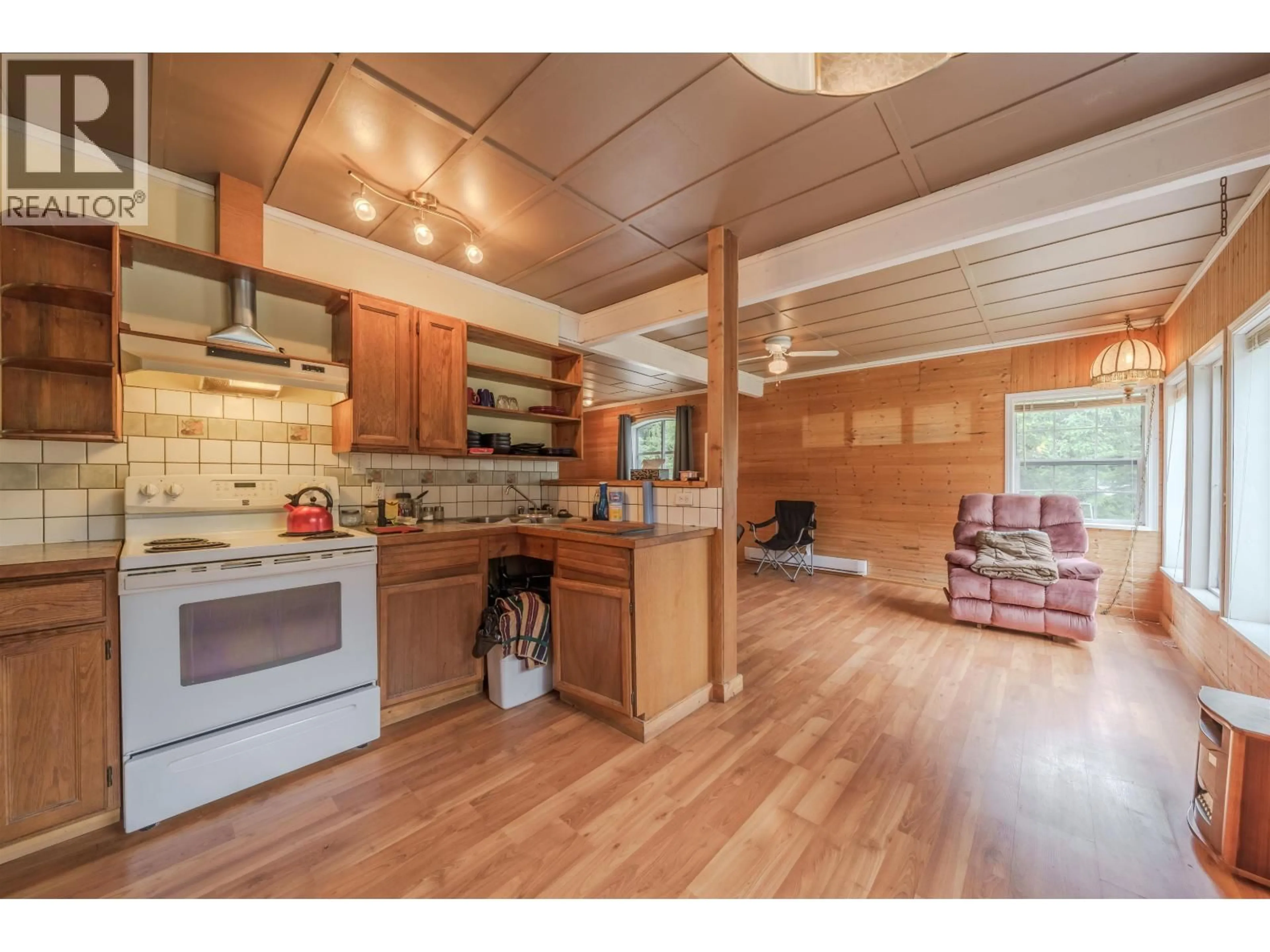 Open concept kitchen, wood/laminate floor for 6116 HIGGINS LAKE ROAD, Deka Lake / Sulphurous / Hathaway Lakes British Columbia V0K1X3