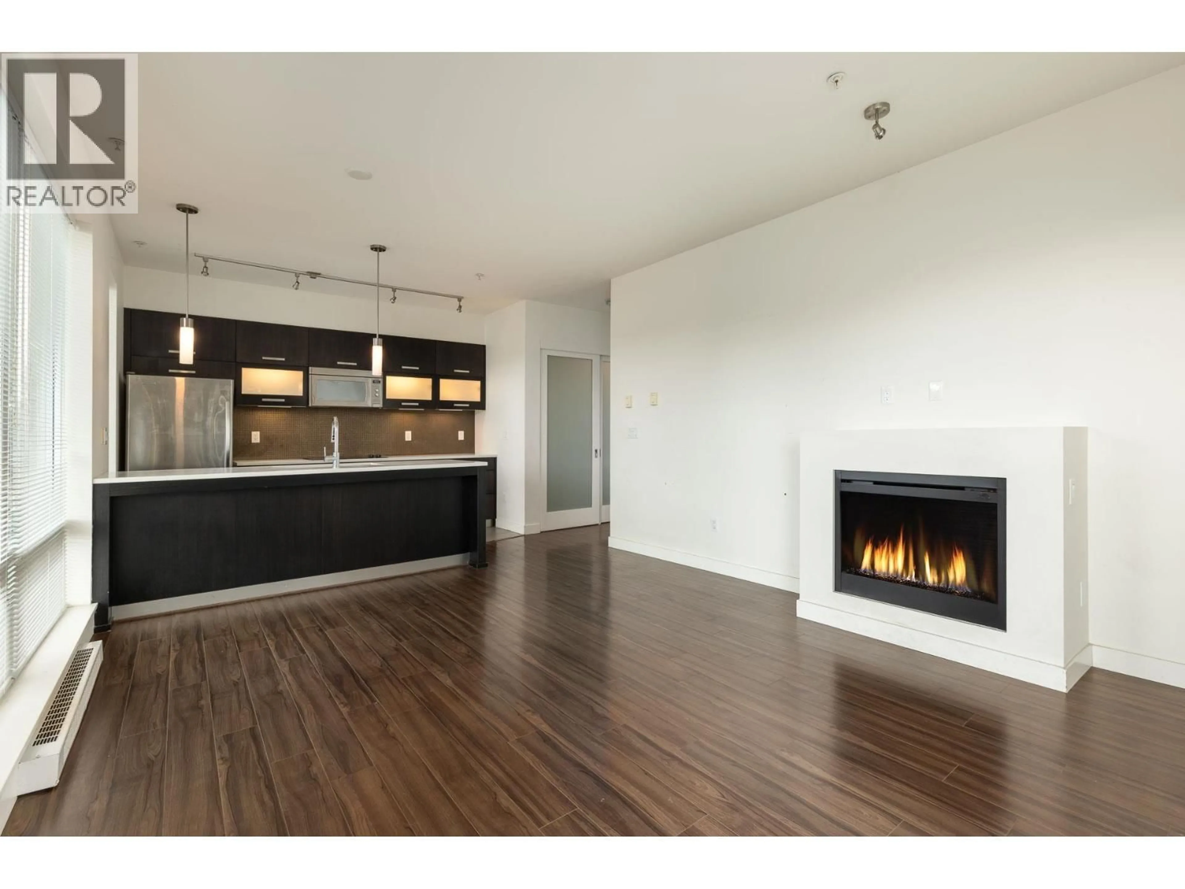 Open concept kitchen, wood/laminate floor for 218 - 3333 MAIN STREET, Vancouver British Columbia V5V3M8