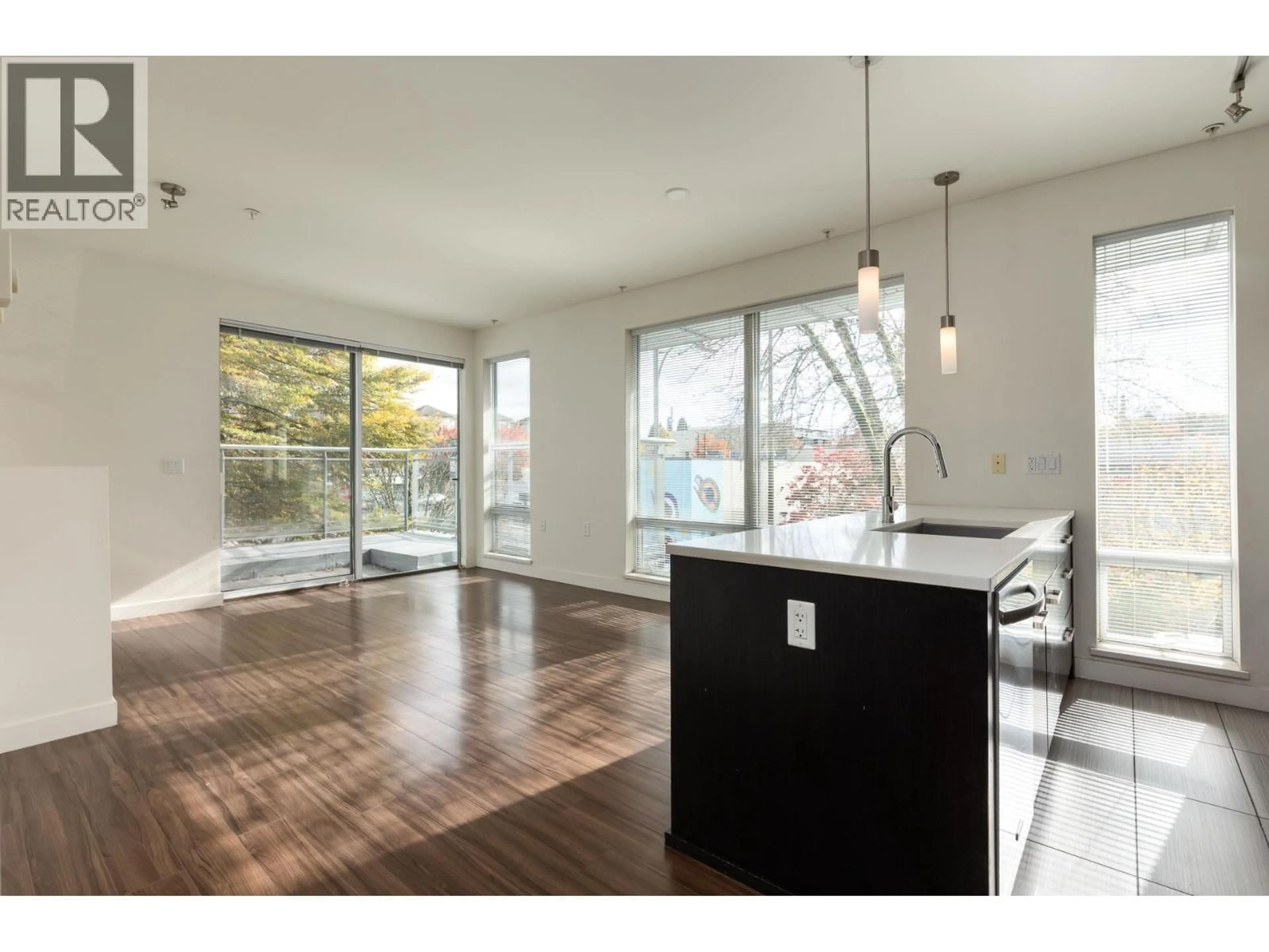Open concept kitchen, wood/laminate floor for 218 - 3333 MAIN STREET, Vancouver British Columbia V5V3M8