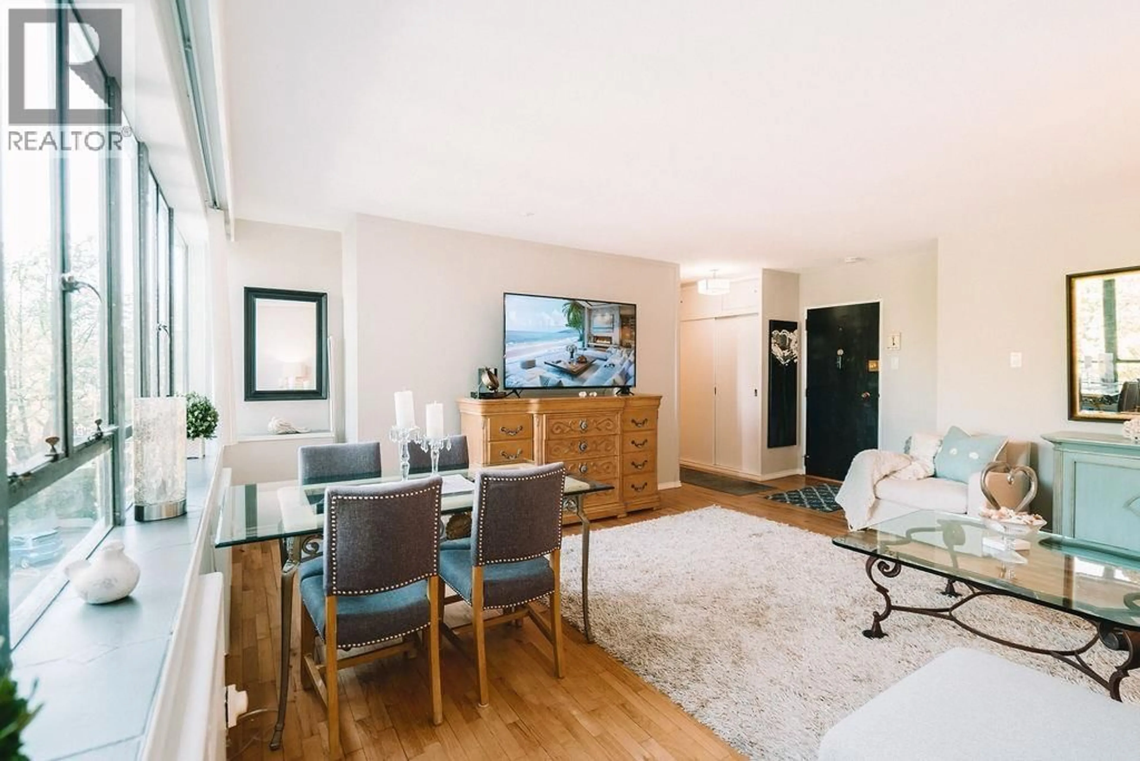 Living room with furniture, wood/laminate floor for 310 - 1445 MARPOLE AVENUE, Vancouver British Columbia V6H1S5