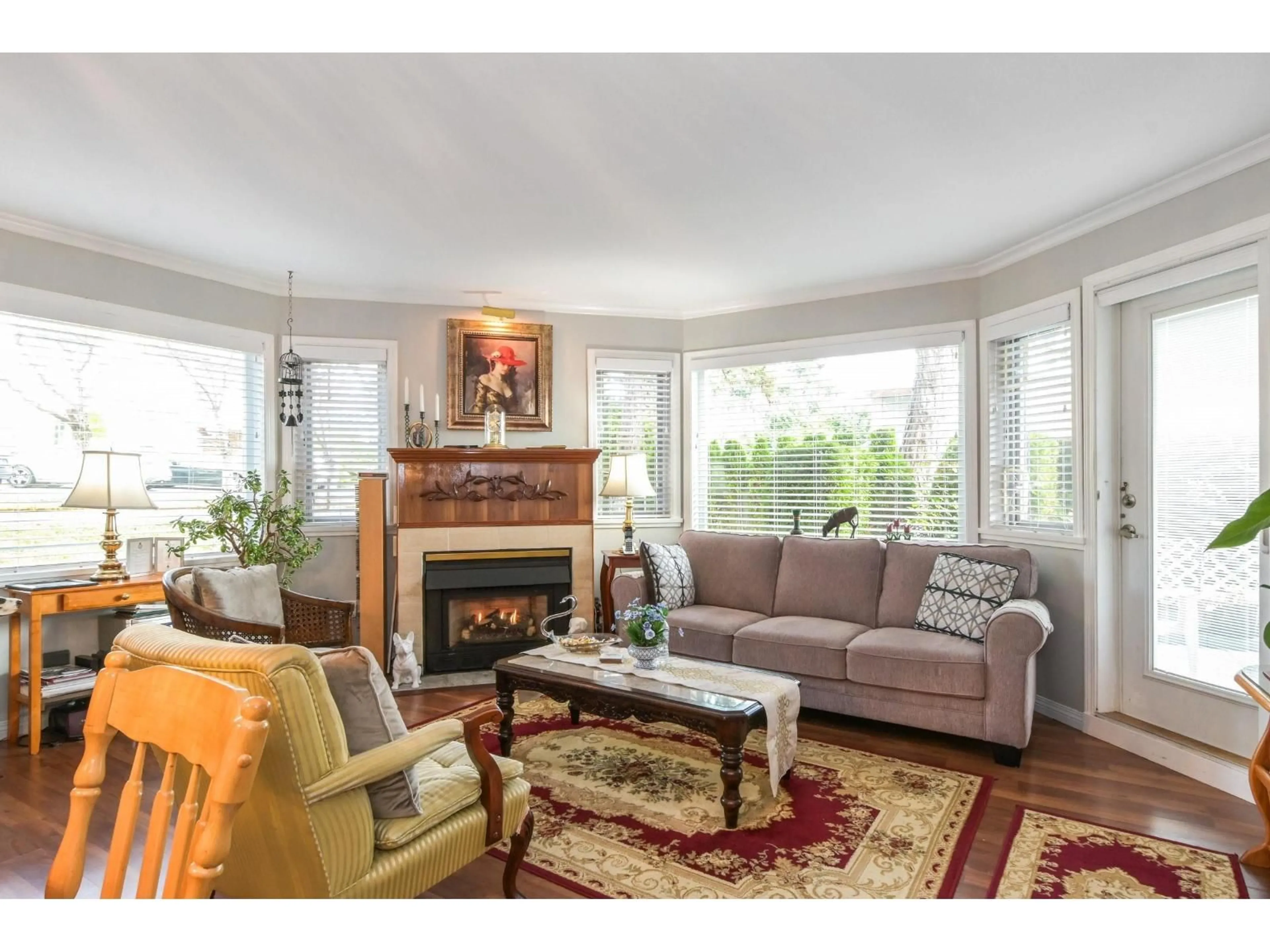 Living room with furniture, wood/laminate floor for 107 - 13965 16, Surrey British Columbia V4A1P8