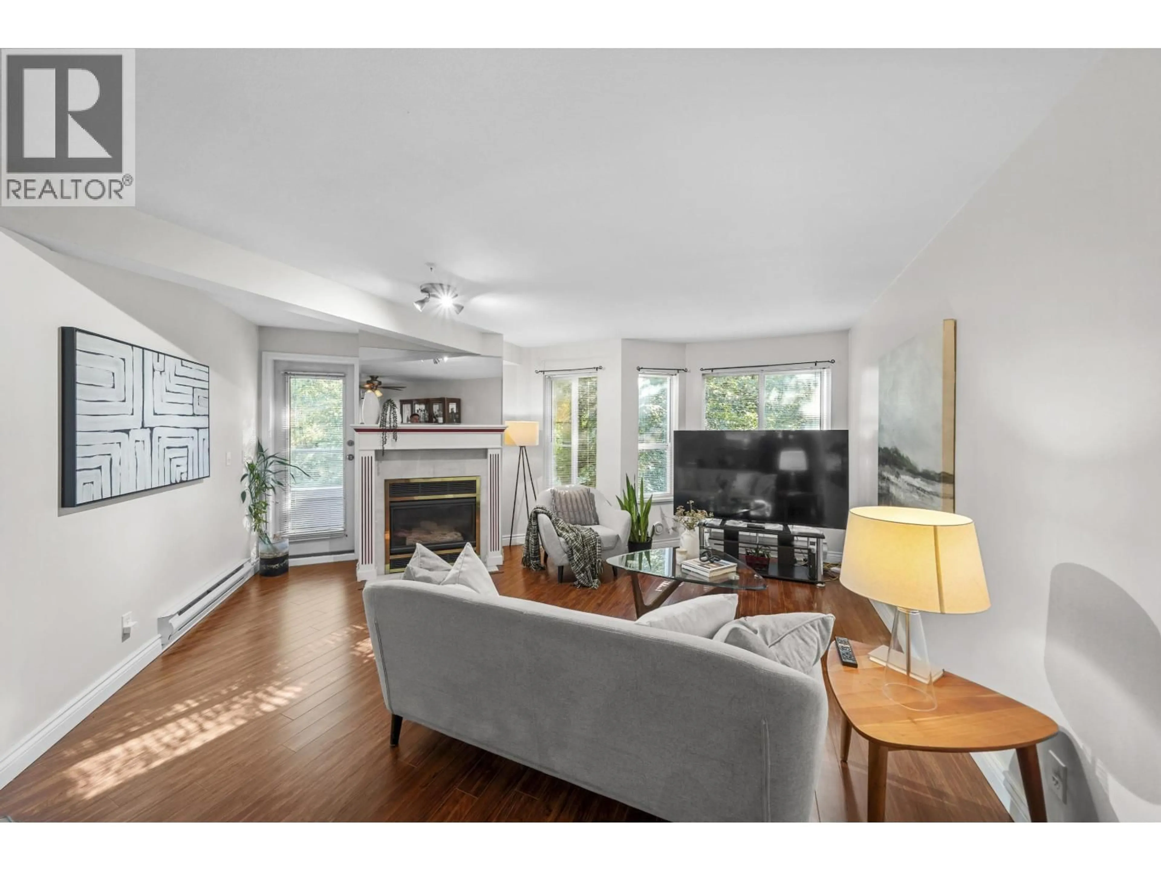 Living room with furniture, wood/laminate floor for 206 - 2620 JANE STREET, Port Coquitlam British Columbia V3C6J3