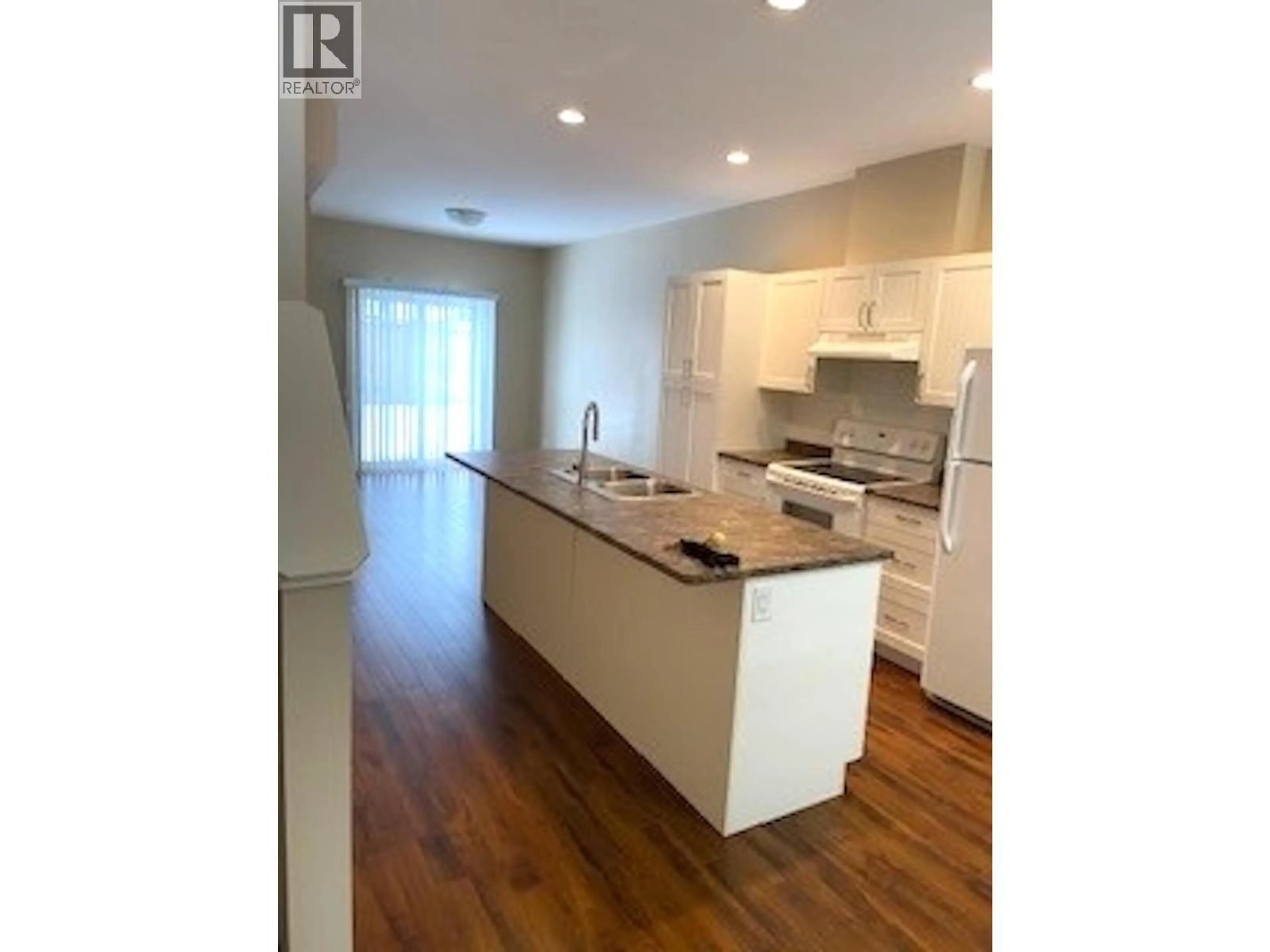 Open concept kitchen, wood/laminate floor for 122 - 11008 102 AVENUE, Fort St. John British Columbia V1J2G2
