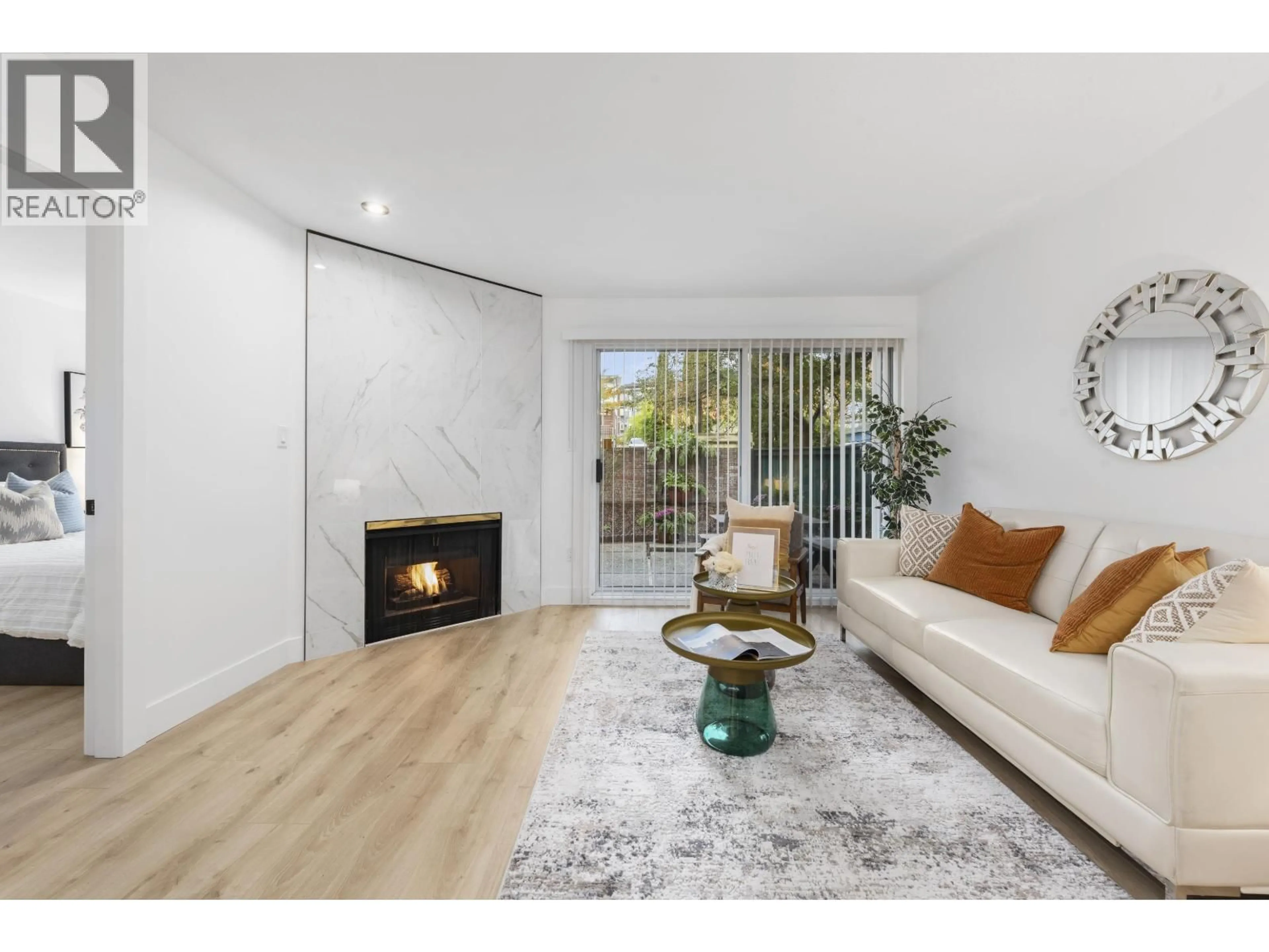 Living room with furniture, wood/laminate floor for 111 - 5350 VICTORY STREET, Burnaby British Columbia V5J1T1