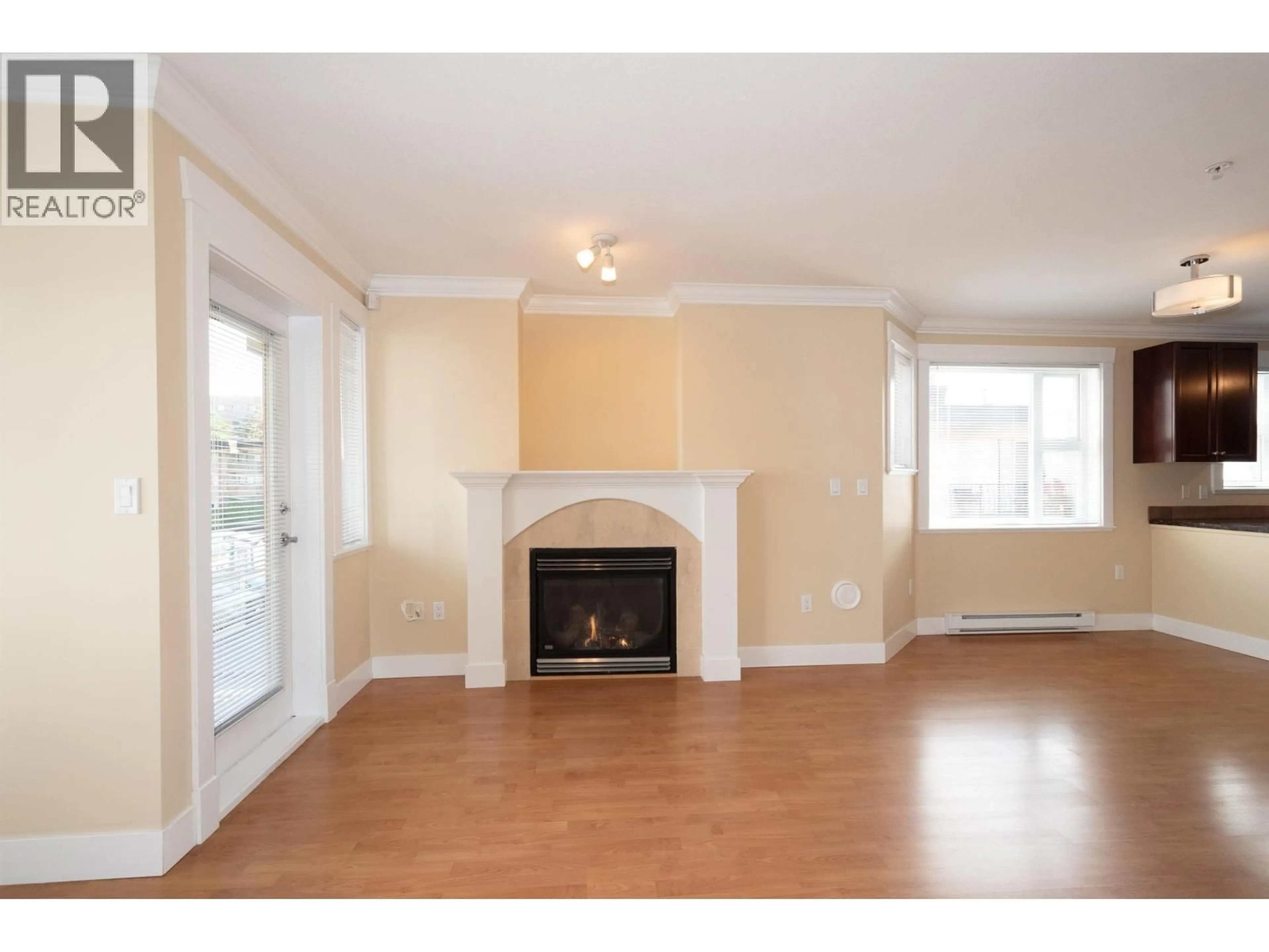 Living room with furniture, wood/laminate floor for 304 - 152 12TH STREET, North Vancouver British Columbia V7L2J4