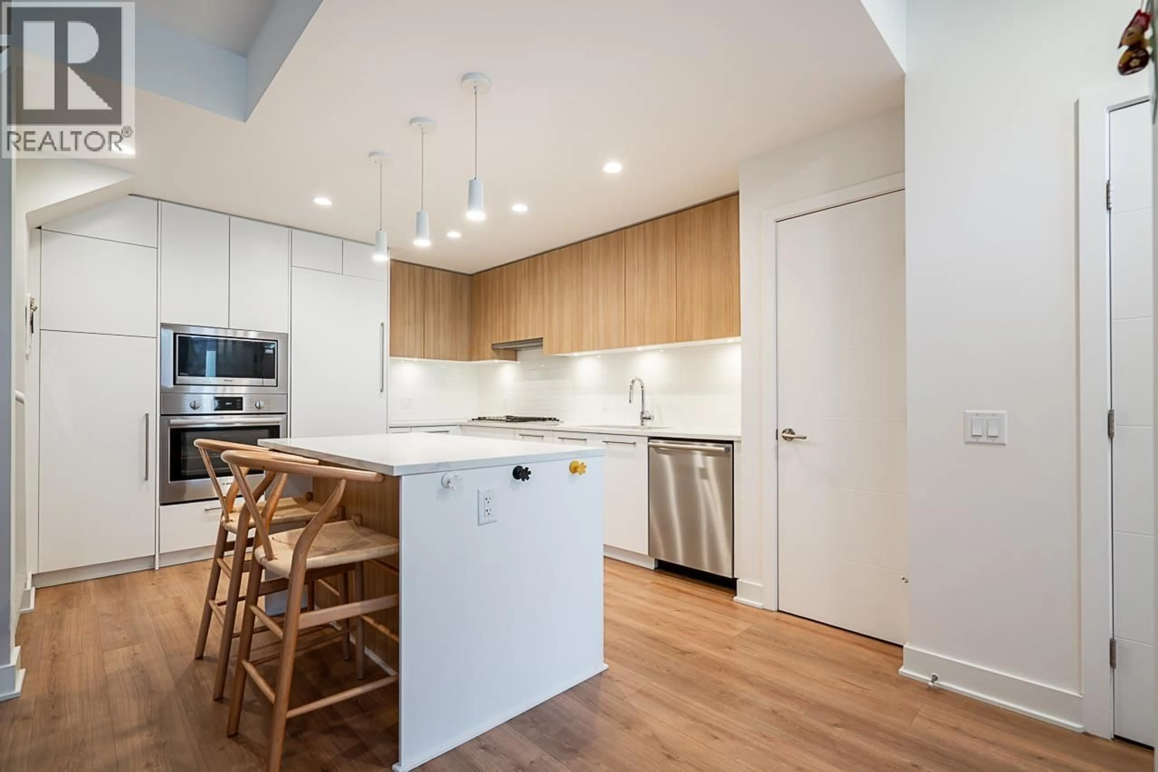 Open concept kitchen, wood/laminate floor for 103 - 2035 GLENAIRE DRIVE, North Vancouver British Columbia V7P1Y2