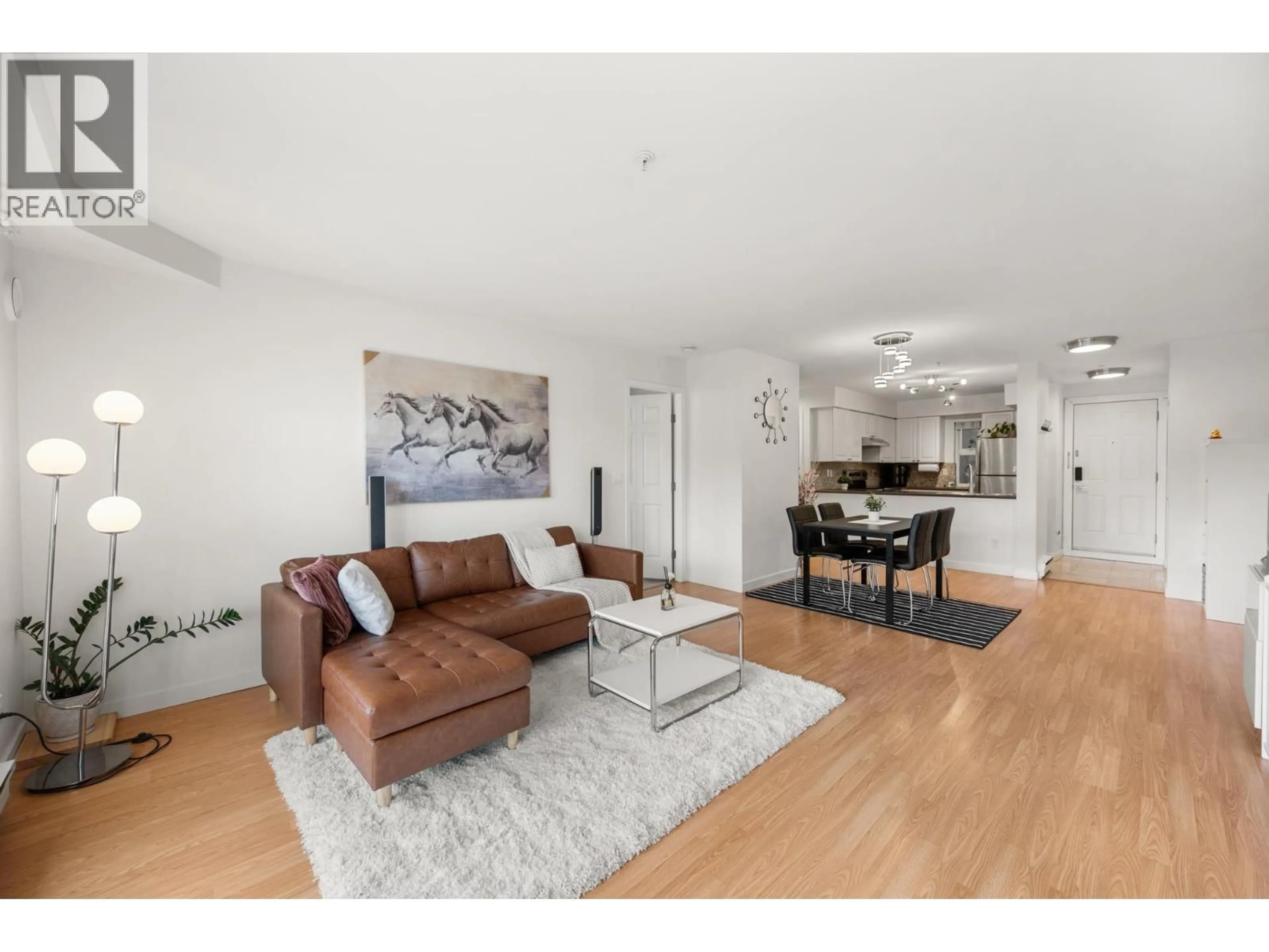 Living room with furniture, wood/laminate floor for 106 - 1570 PRAIRIE AVENUE, Port Coquitlam British Columbia V3B1T4