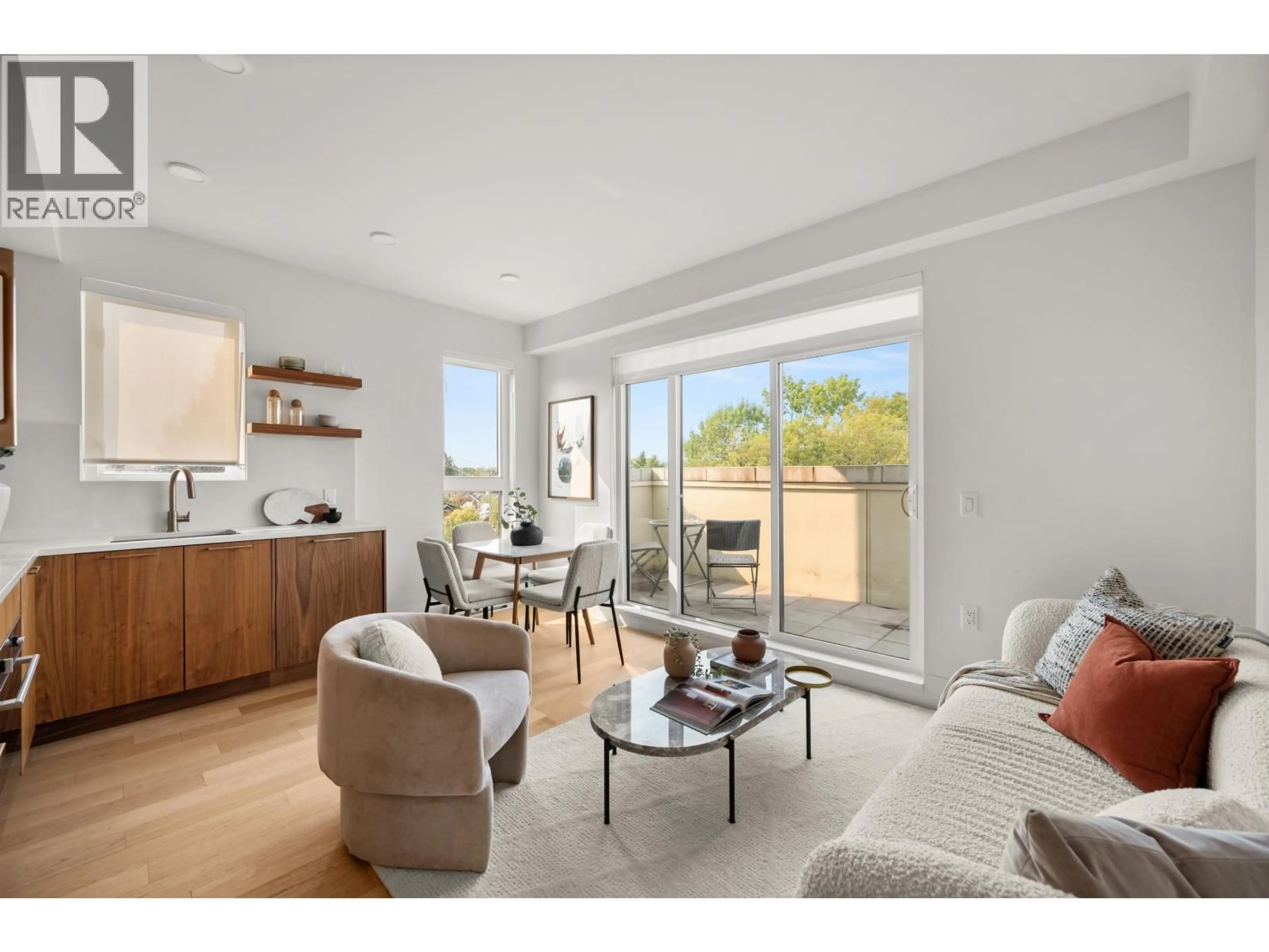 Living room with furniture, wood/laminate floor for 406 - 2550 GARDEN DRIVE, Vancouver British Columbia V5N4X6