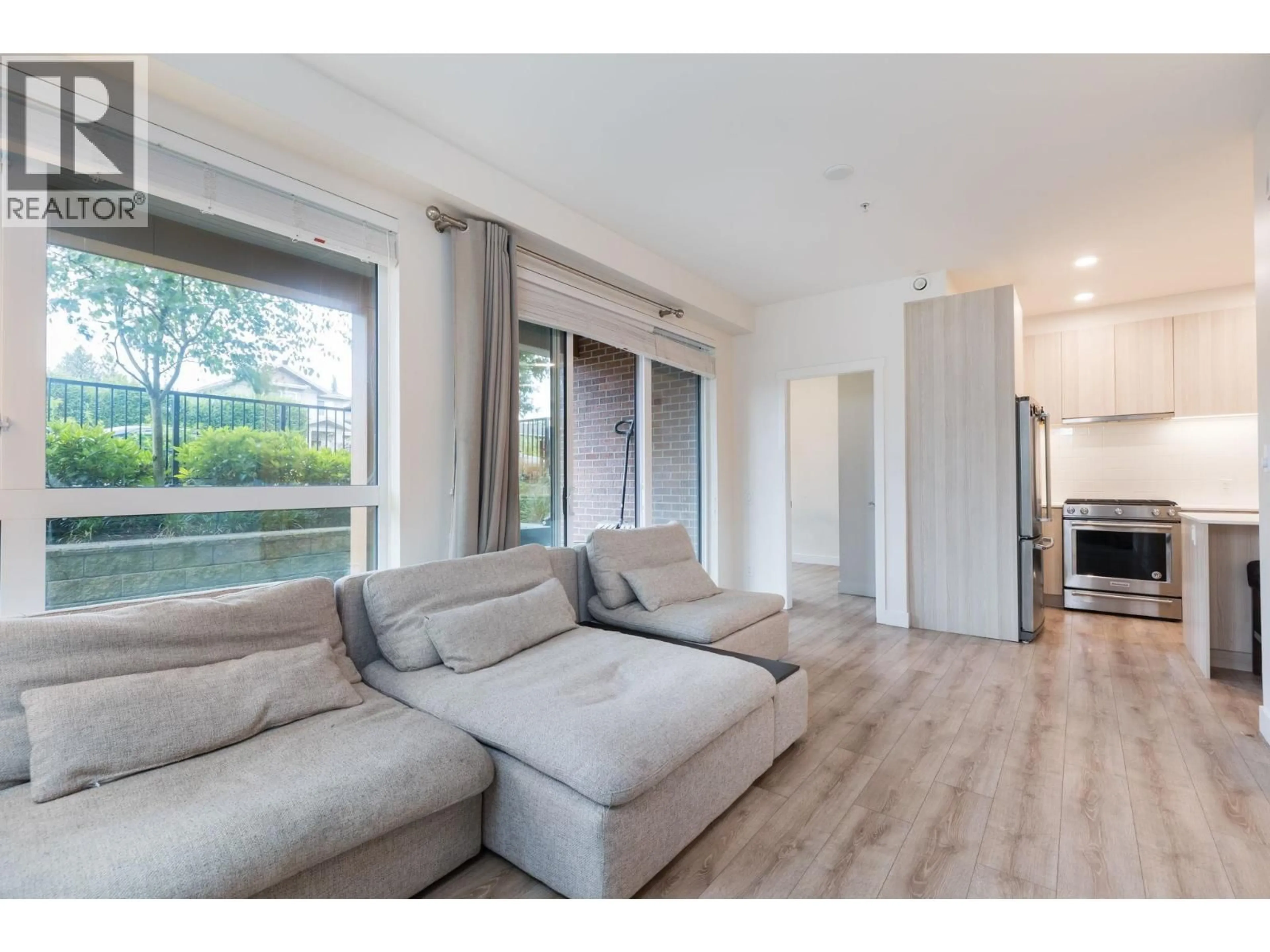 Living room with furniture, wood/laminate floor for 121 - 721 ANSKAR COURT, Coquitlam British Columbia V3J0L4