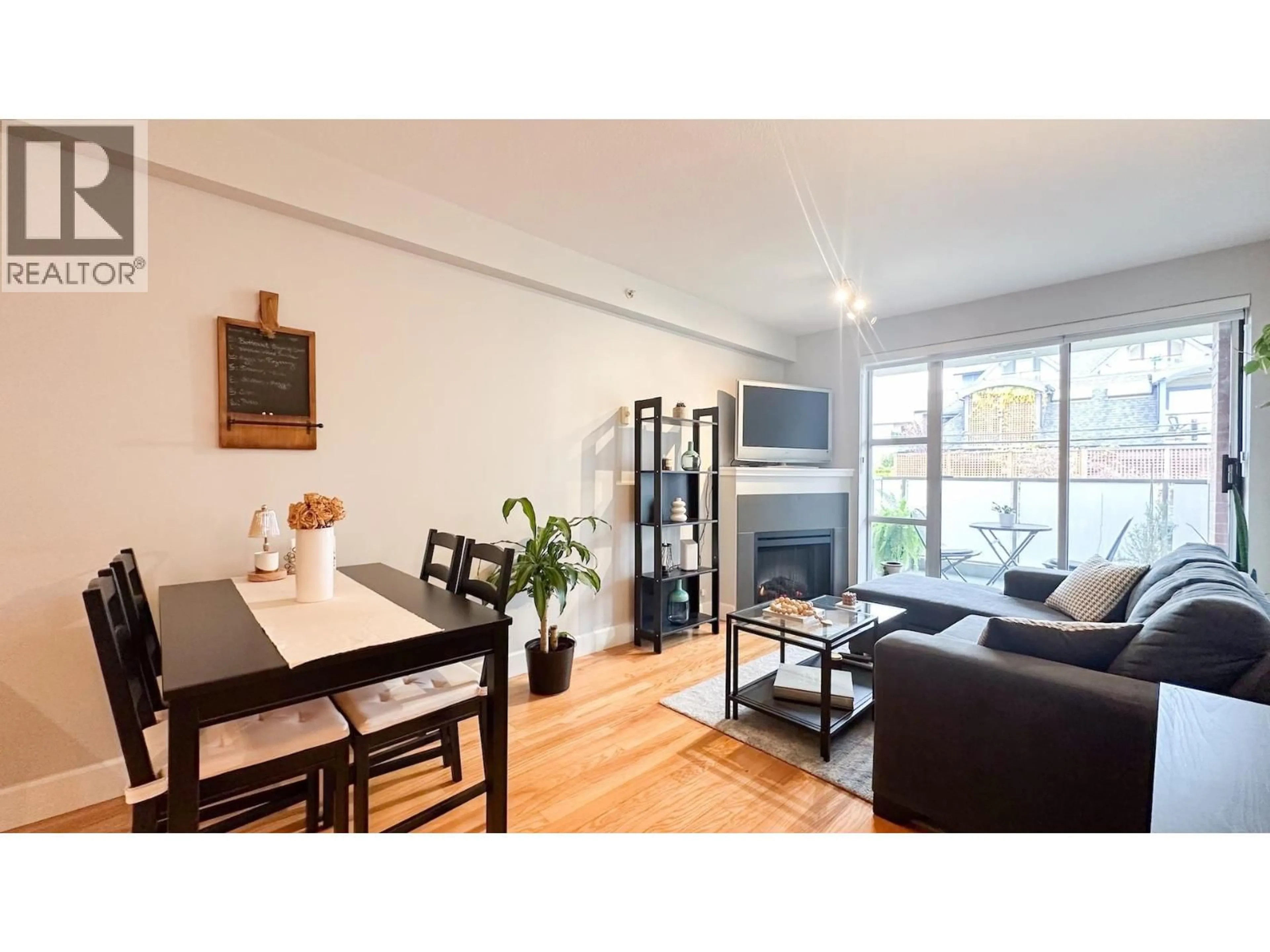 Living room with furniture, wood/laminate floor for 411 - 3811 HASTINGS STREET, Burnaby British Columbia V5C6V2