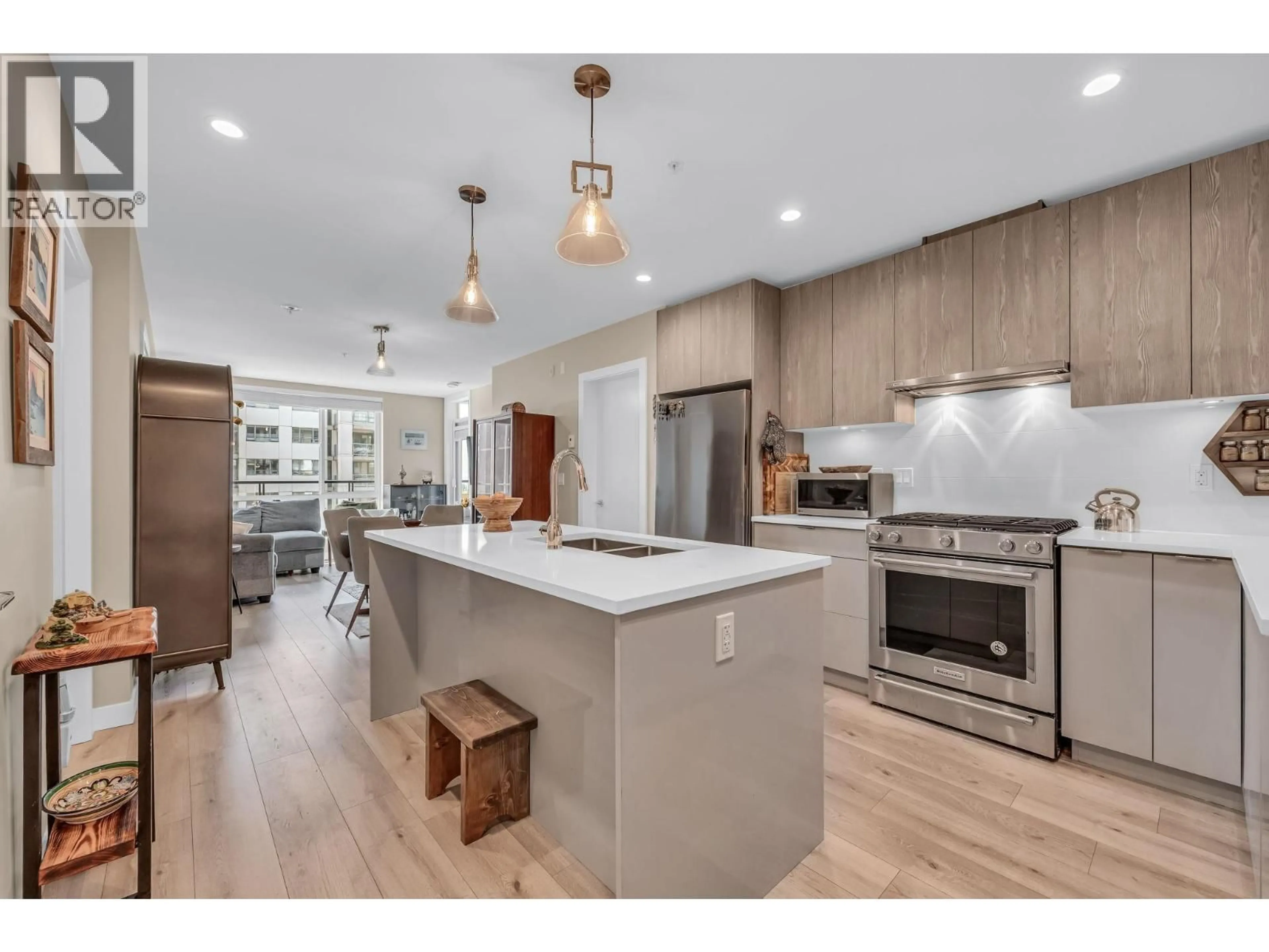 Open concept kitchen, wood/laminate floor for 404 - 128 8TH STREET, North Vancouver British Columbia V7L0H2