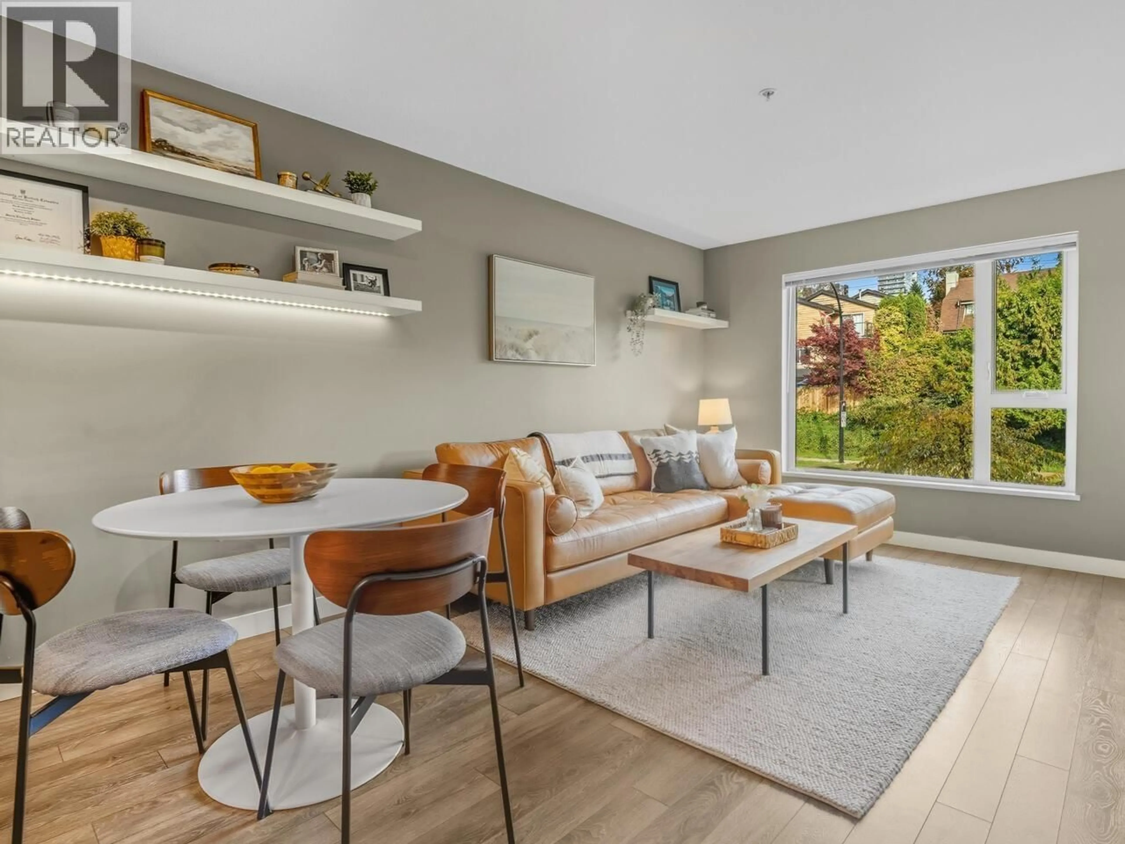 Living room with furniture, wood/laminate floor for 208 - 221 3RD STREET, North Vancouver British Columbia V7L0C1