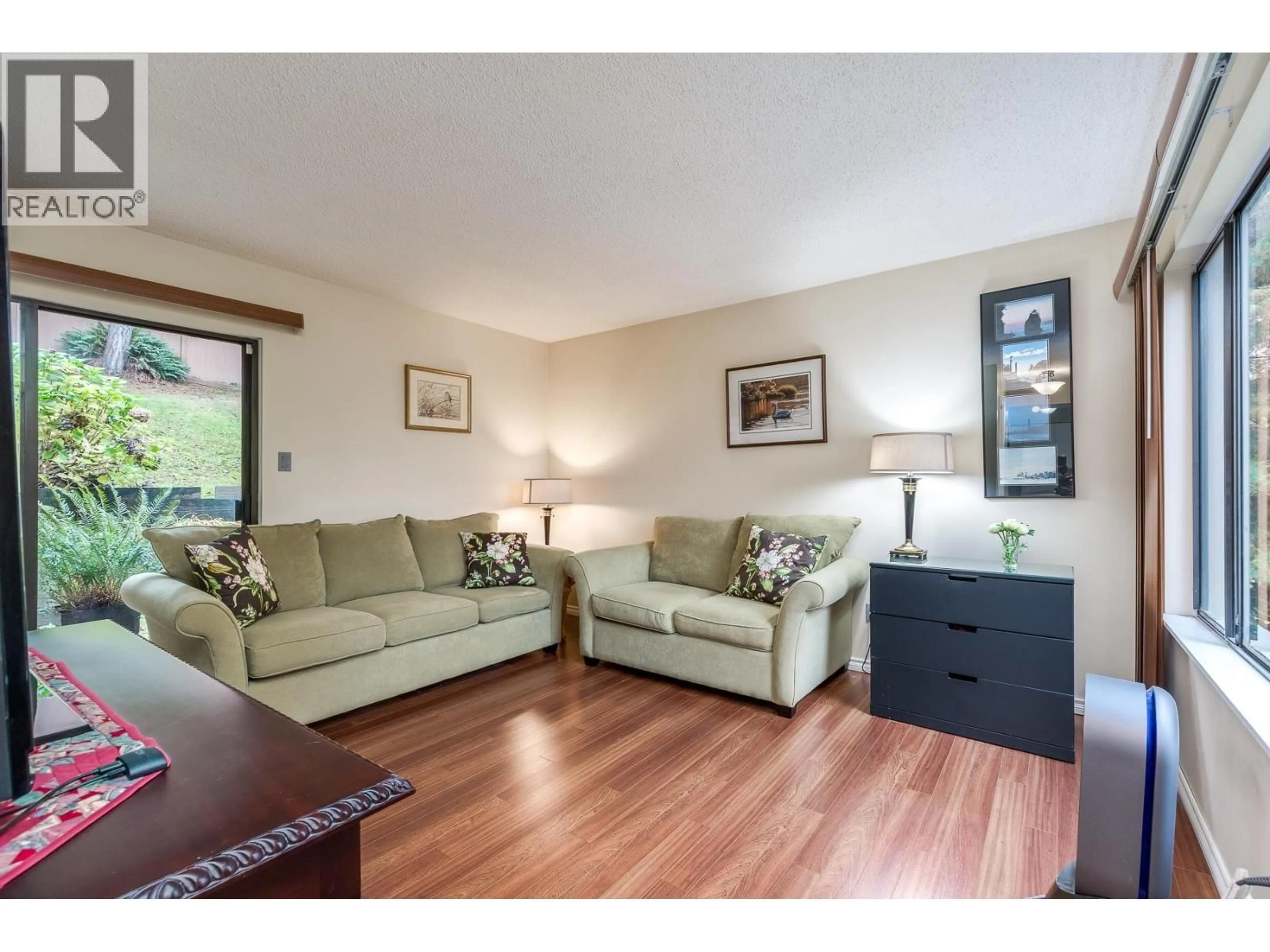 Living room with furniture, wood/laminate floor for 507 CAMBRIDGE WAY, Port Moody British Columbia V3H3V1
