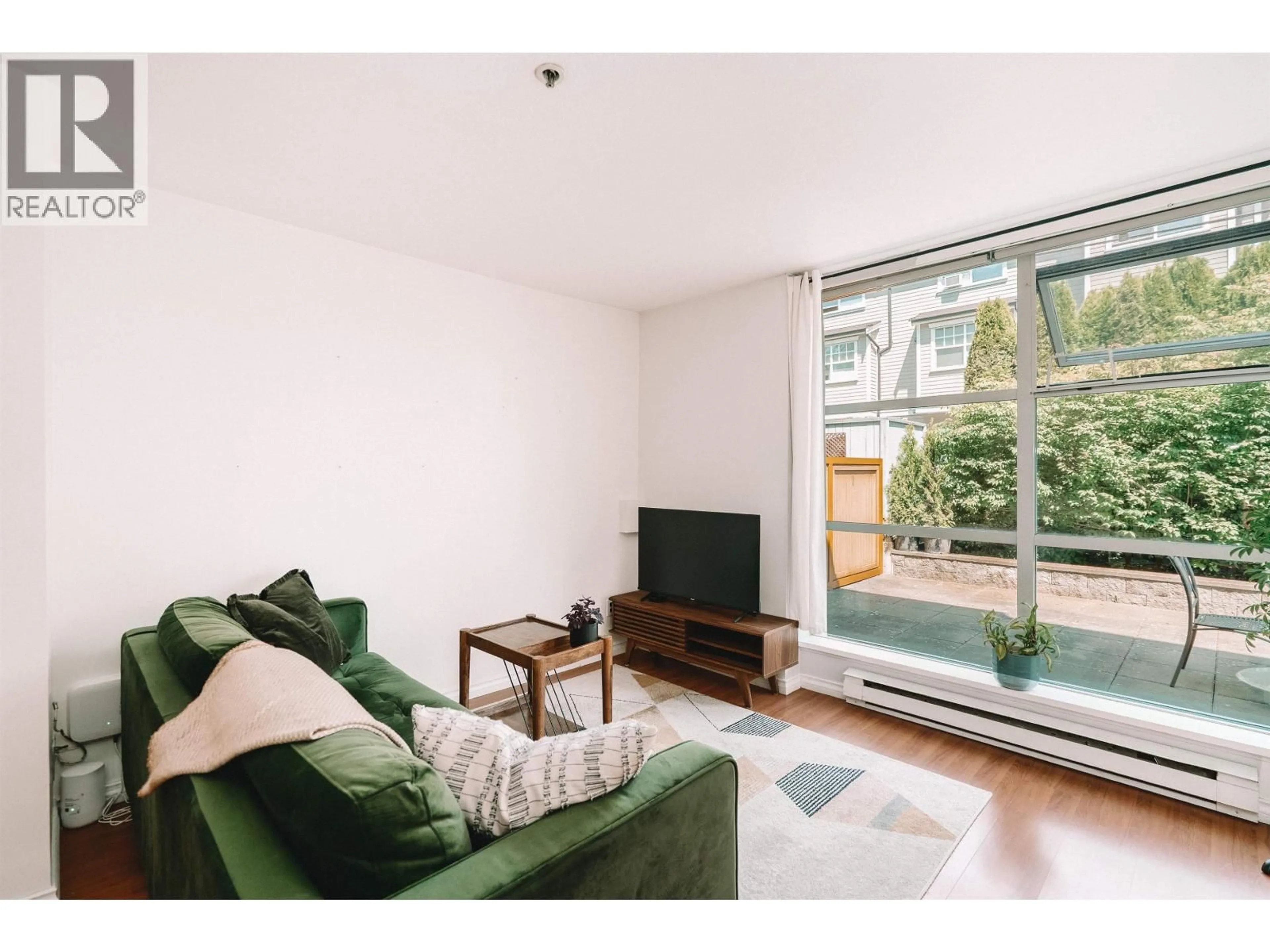 Living room with furniture, wood/laminate floor for 106 - 3168 LAUREL STREET, Vancouver British Columbia V5Z3T8