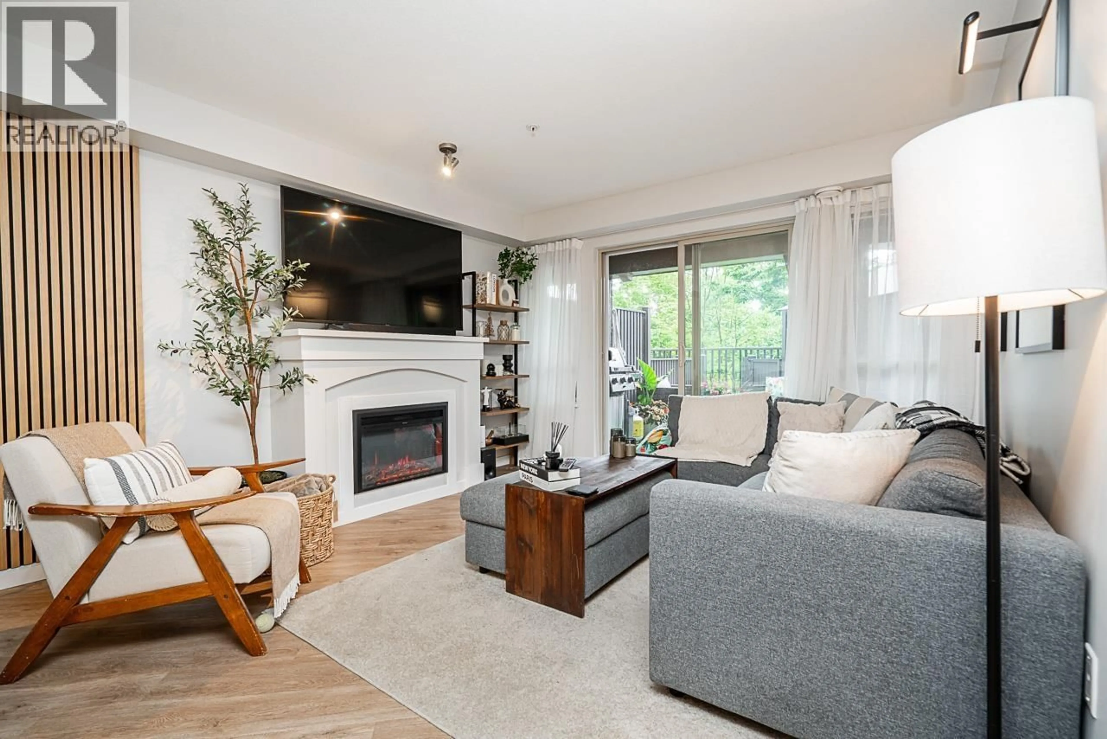 Living room with furniture, wood/laminate floor for 211 - 3132 DAYANEE SPRINGS BOULEVARD, Coquitlam British Columbia V3E0B5