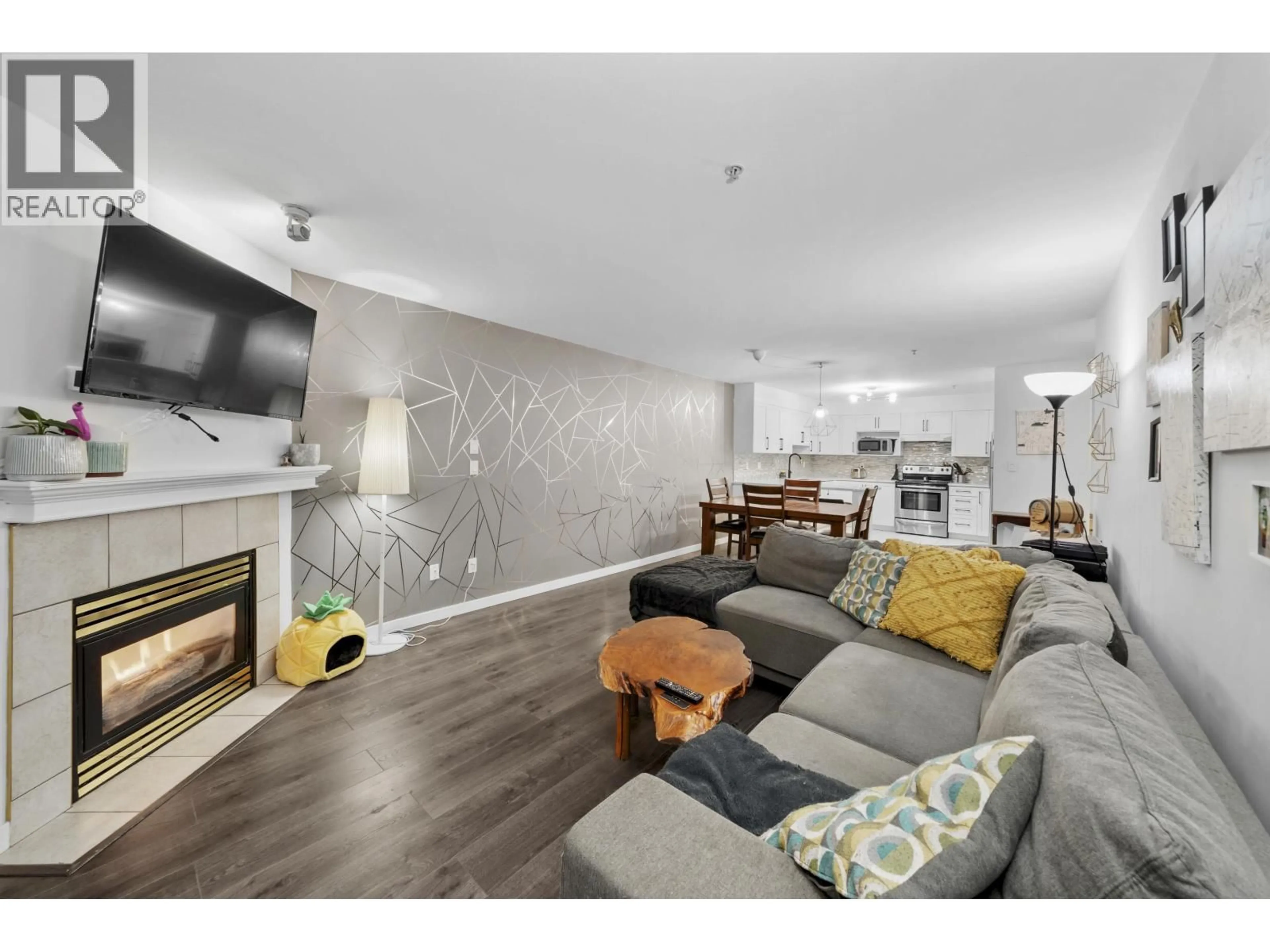 Living room with furniture, wood/laminate floor for 311 - 121 SHORELINE CIRCLE, Port Moody British Columbia V3H5G2