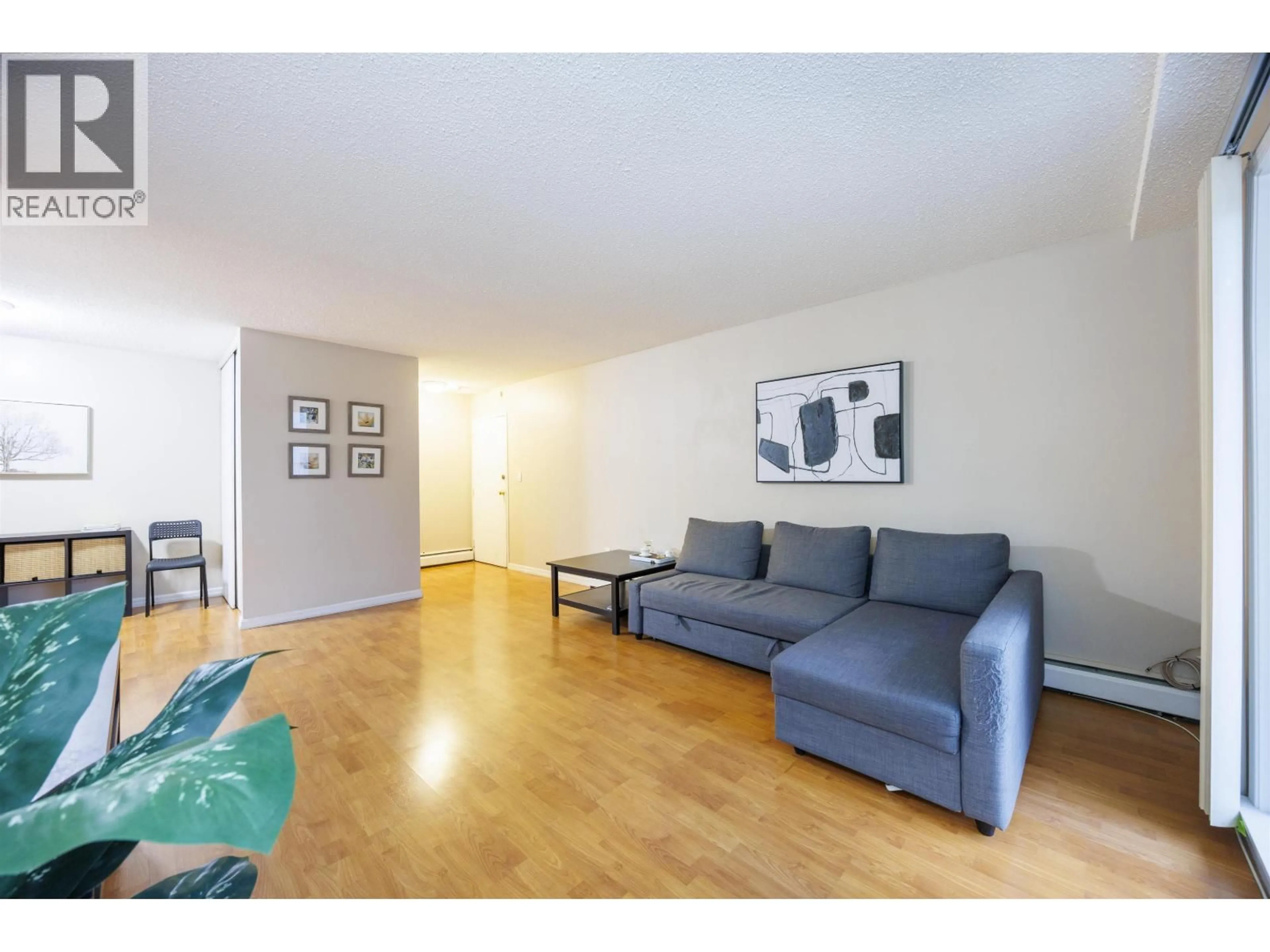 Living room with furniture, wood/laminate floor for 201 - 7200 LINDSAY ROAD, Richmond British Columbia V7C3M6