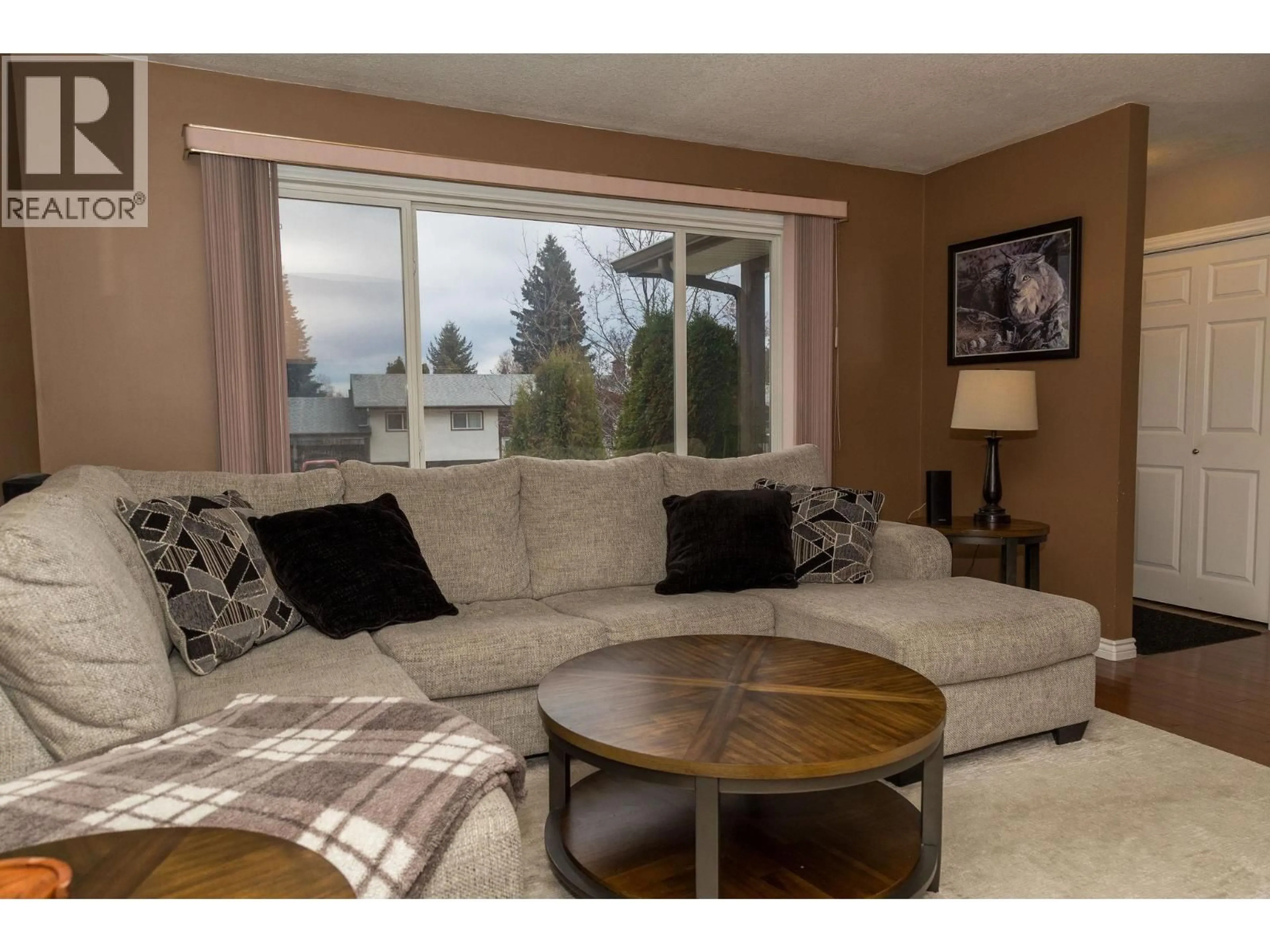 Living room with furniture, wood/laminate floor for 4176 NEHRING AVENUE, Prince George British Columbia V2N3G1