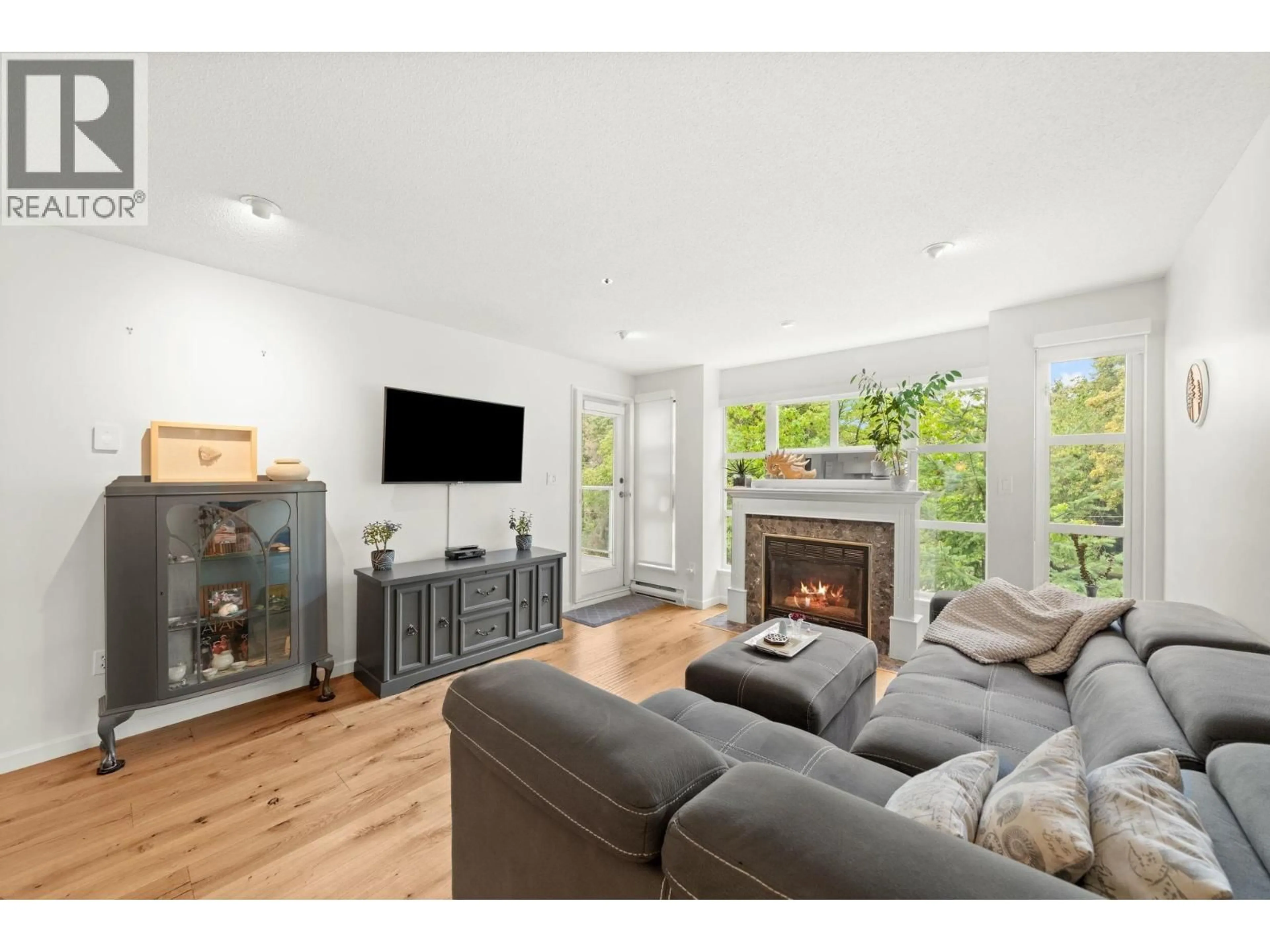 Living room with furniture, wood/laminate floor for 301 - 8728 SW MARINE DRIVE, Vancouver British Columbia V6P6A4