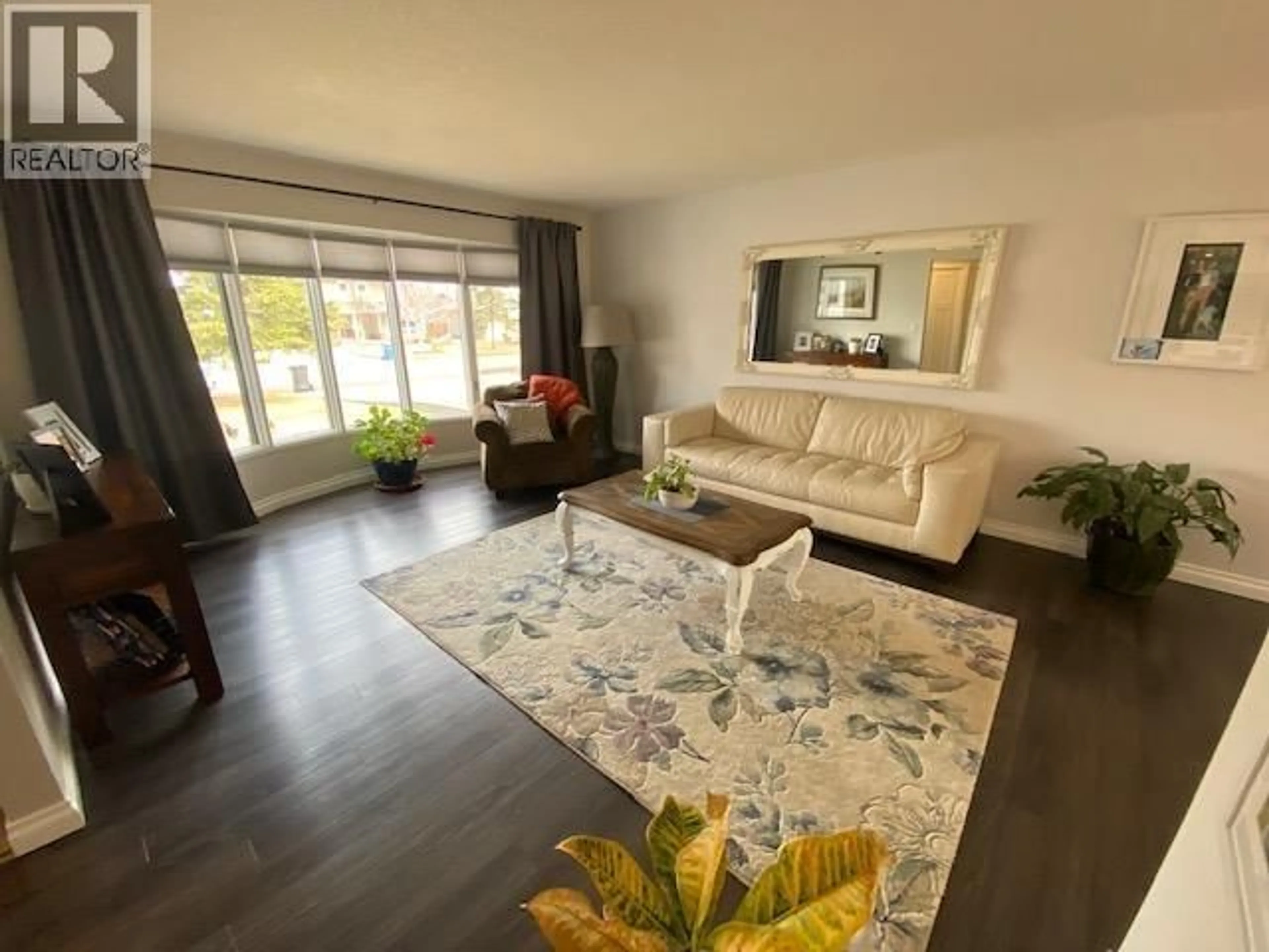 Living room with furniture, wood/laminate floor for 10515 114 AVENUE, Fort St. John British Columbia V1J6H7