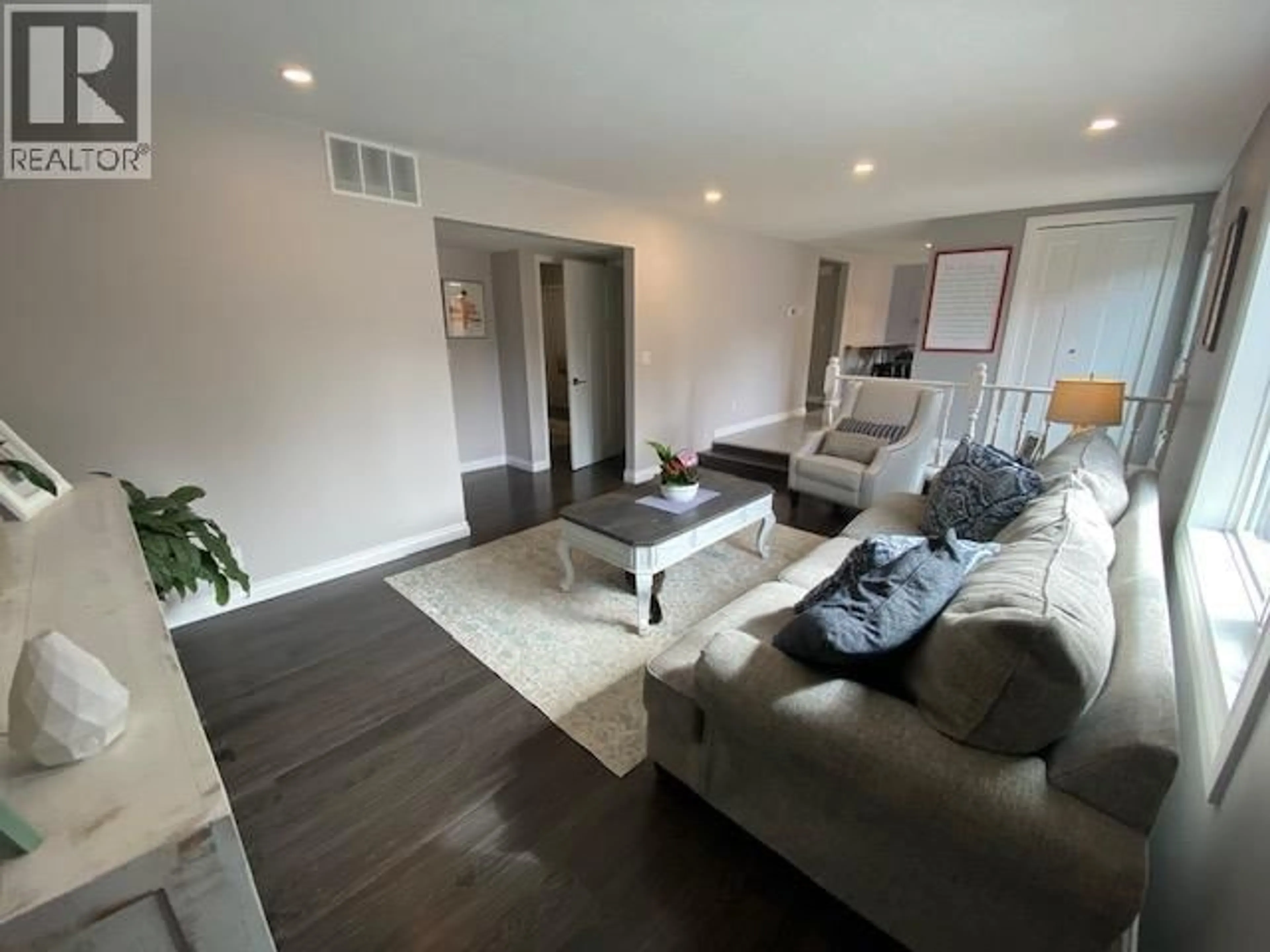 Living room with furniture, wood/laminate floor for 10515 114 AVENUE, Fort St. John British Columbia V1J6H7