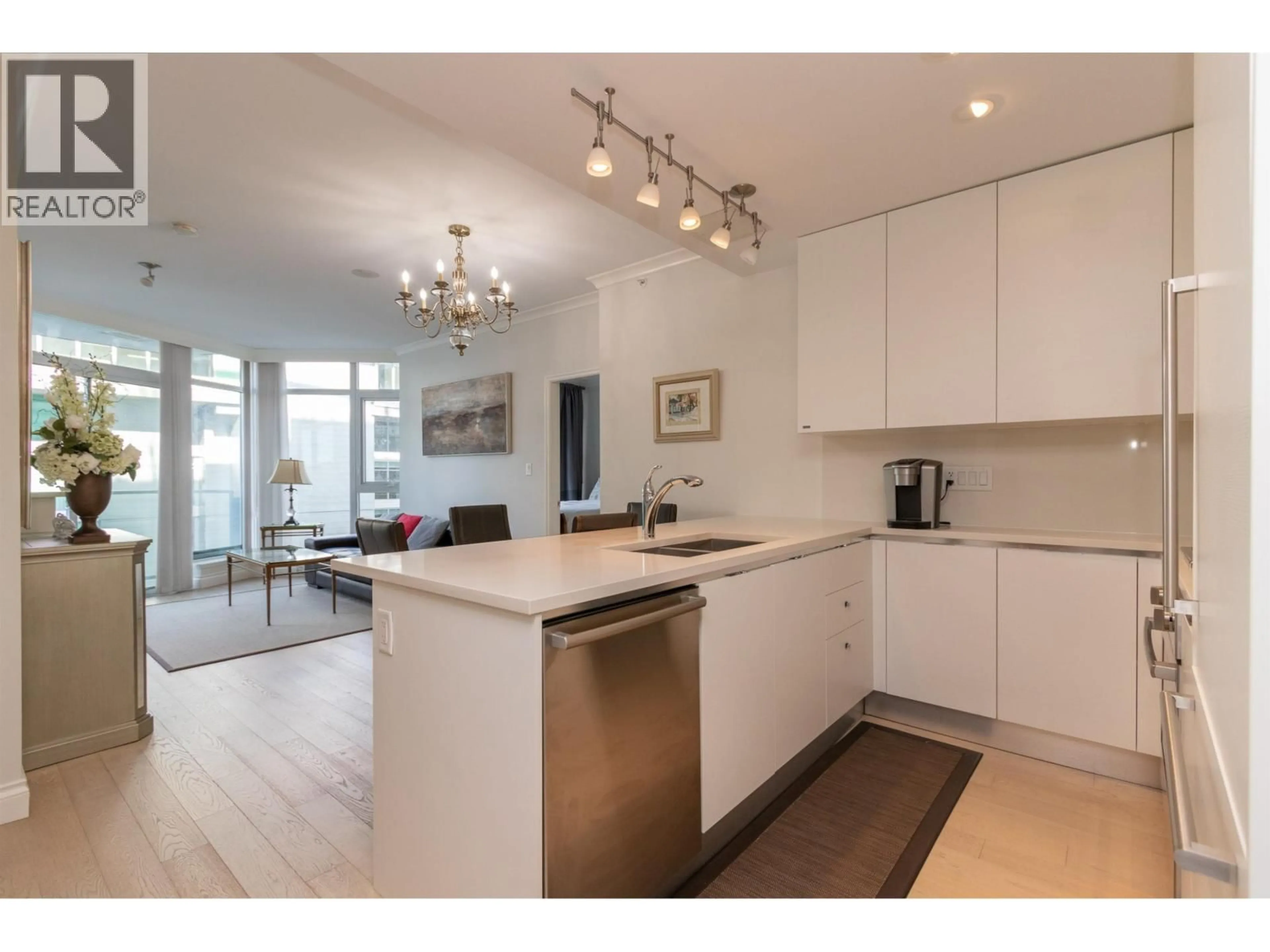 Open concept kitchen, wood/laminate floor for 705 - 199 VICTORY SHIP WAY, North Vancouver British Columbia V7N0E2
