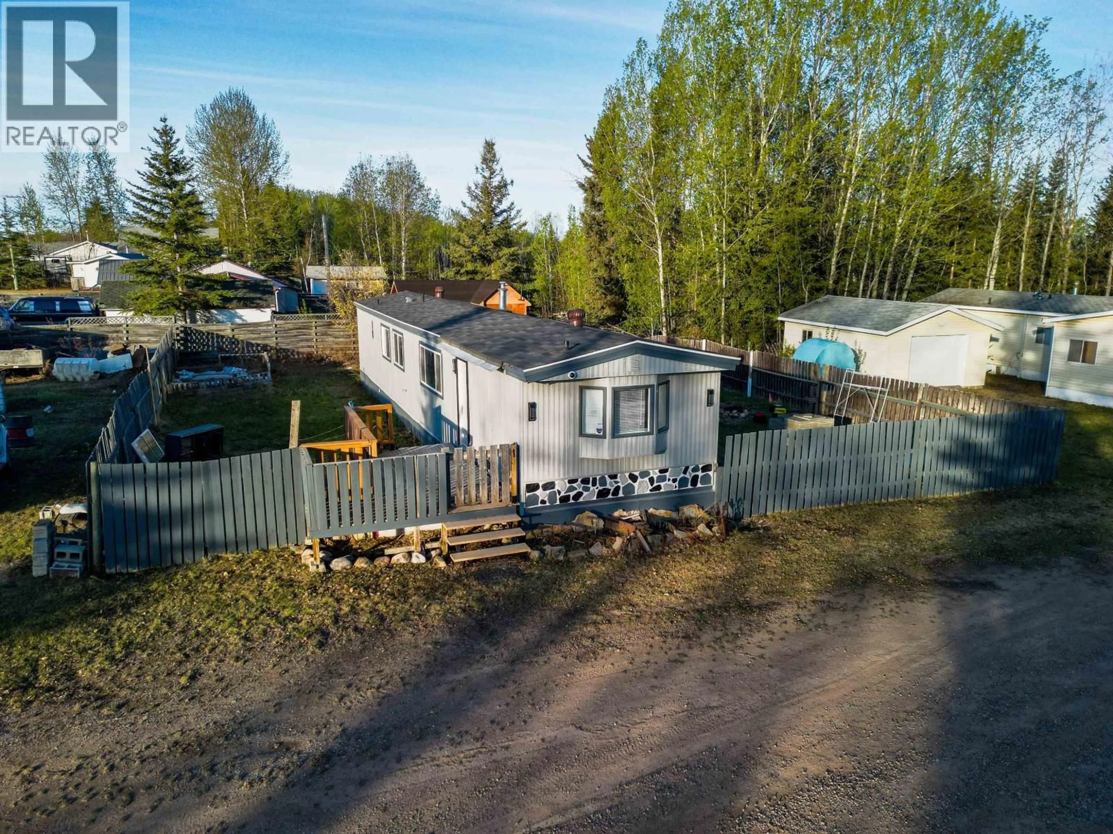 A pic from outside/outdoor area/front of a property/back of a property/a pic from drone, street for 1 - 2963 KLAHANNIE DRIVE, Fort Nelson British Columbia V0C1R0
