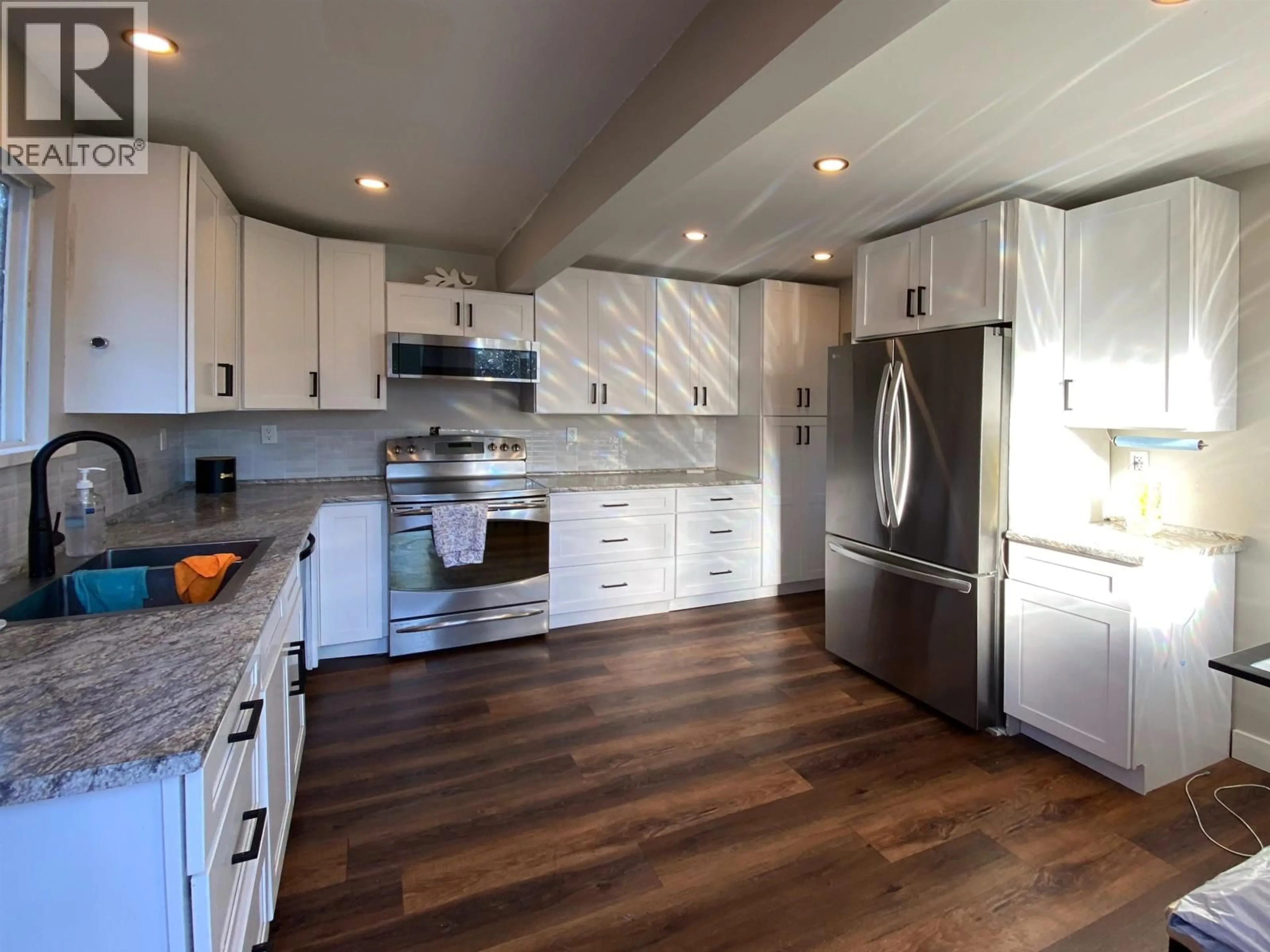 Open concept kitchen, wood/laminate floor for 1423 PIGOTT AVENUE, Prince Rupert British Columbia V8J2E2