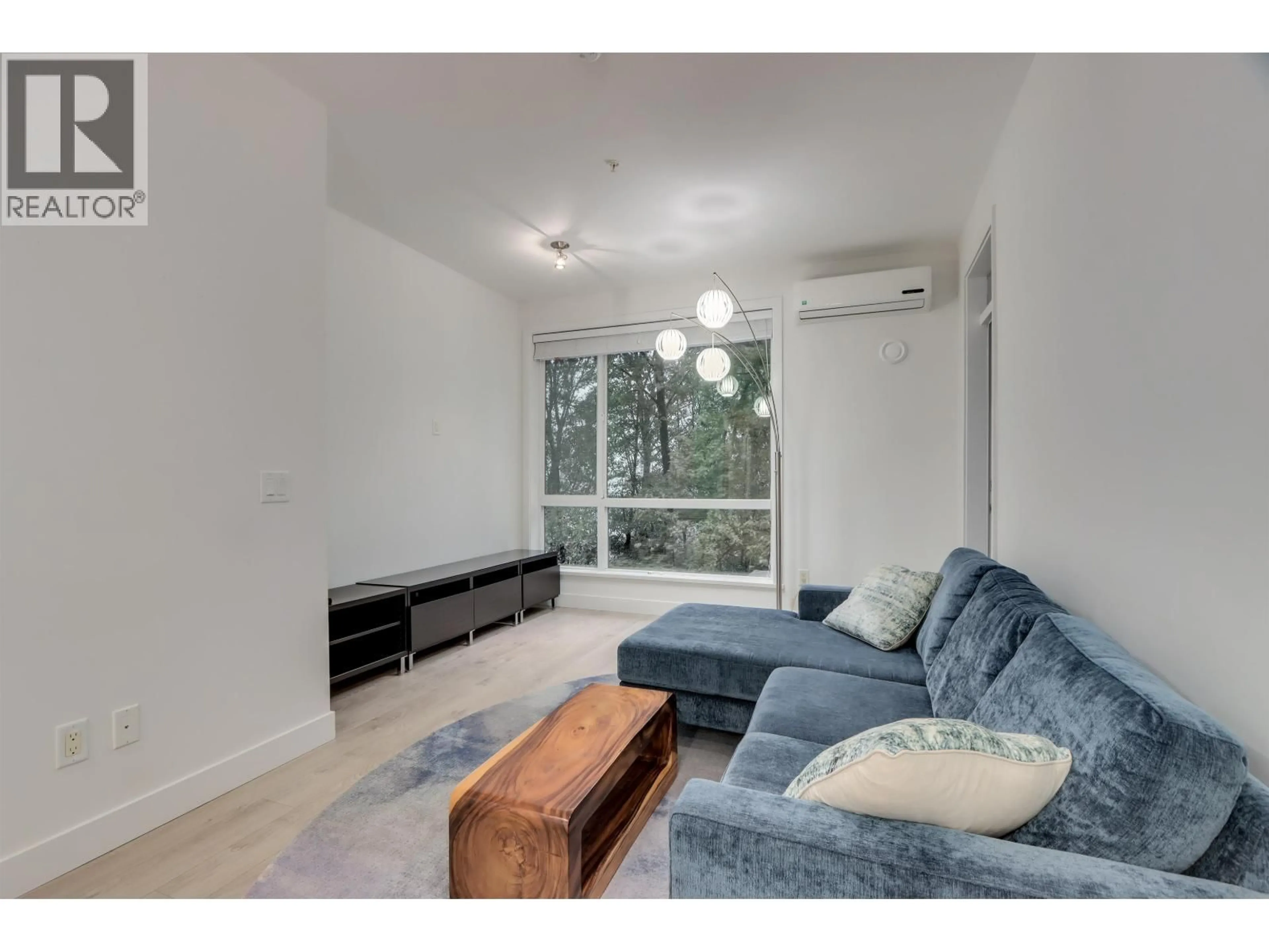 Living room with furniture, wood/laminate floor for 528 - 723 3RD STREET, North Vancouver British Columbia V7M0E4