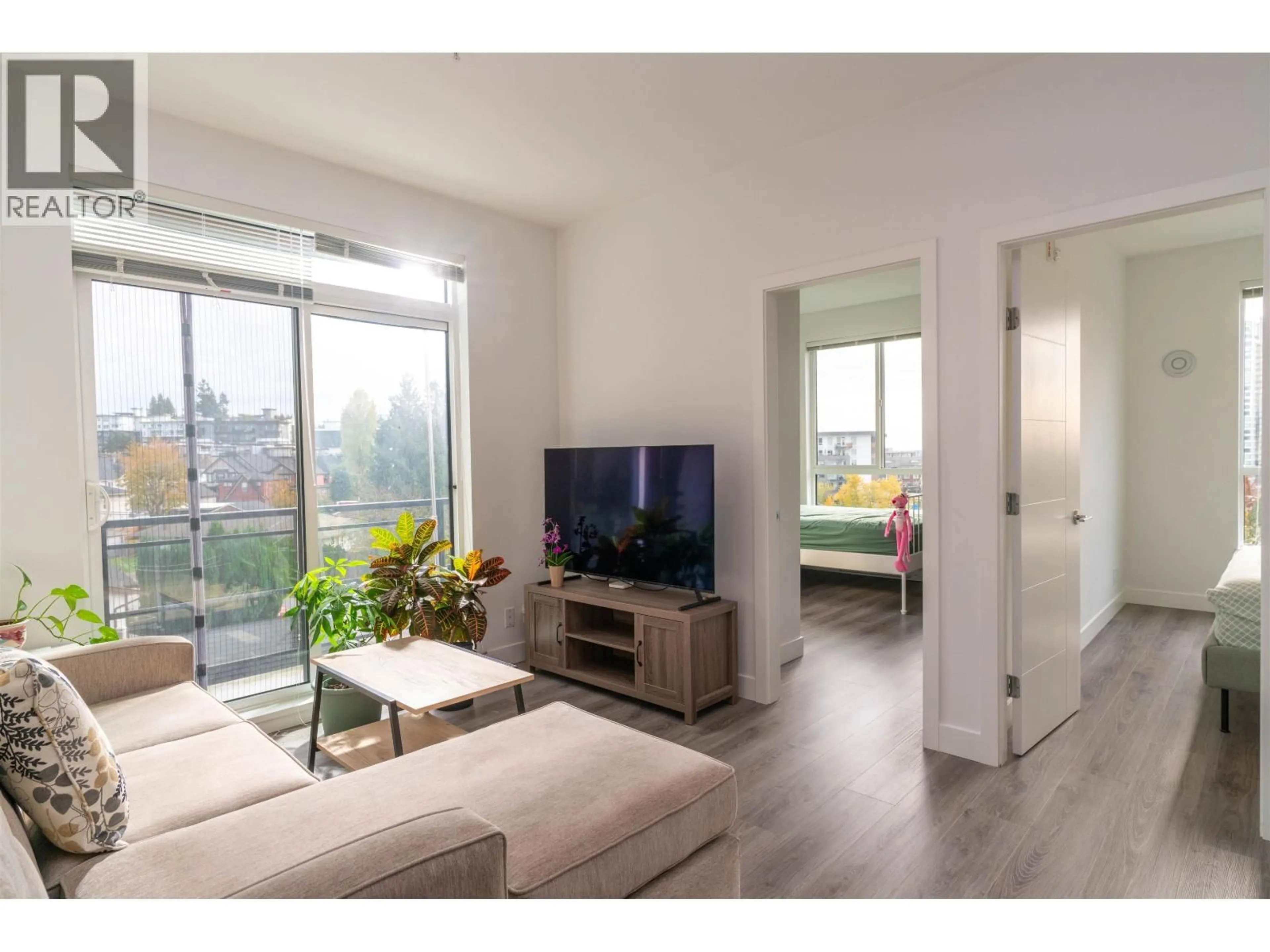 Living room with furniture, wood/laminate floor for 505 - 700 CLARKE ROAD, Coquitlam British Columbia V3J0K5