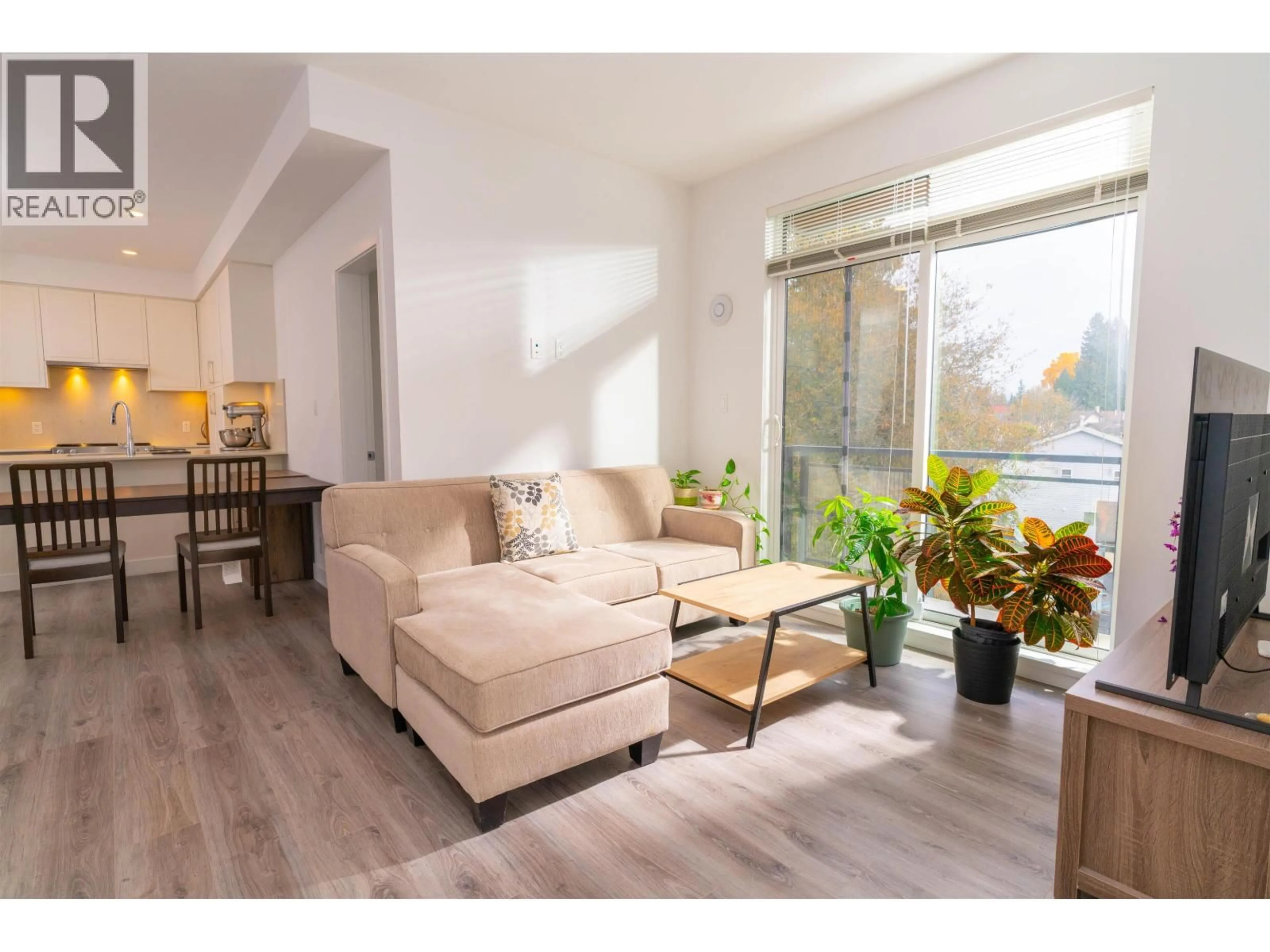 Living room with furniture, wood/laminate floor for 505 - 700 CLARKE ROAD, Coquitlam British Columbia V3J0K5