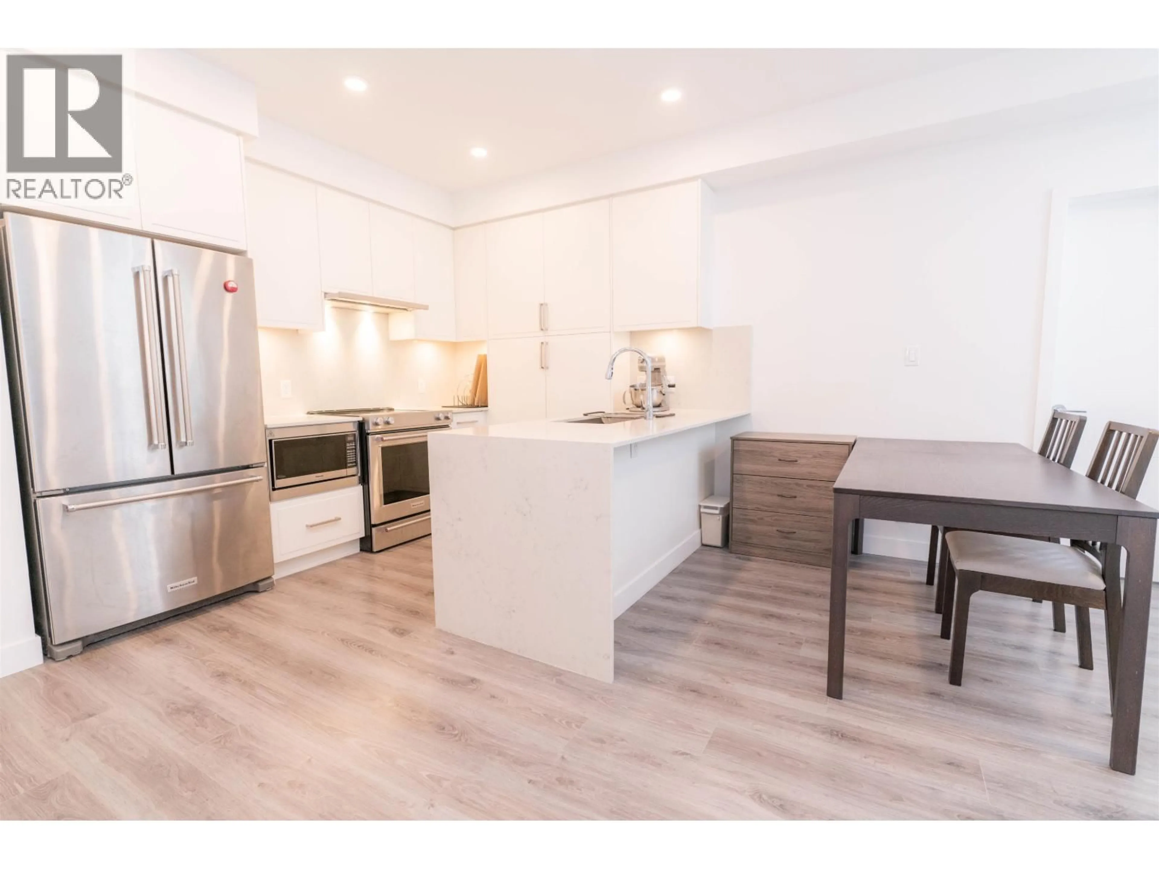 Open concept kitchen, wood/laminate floor for 505 - 700 CLARKE ROAD, Coquitlam British Columbia V3J0K5