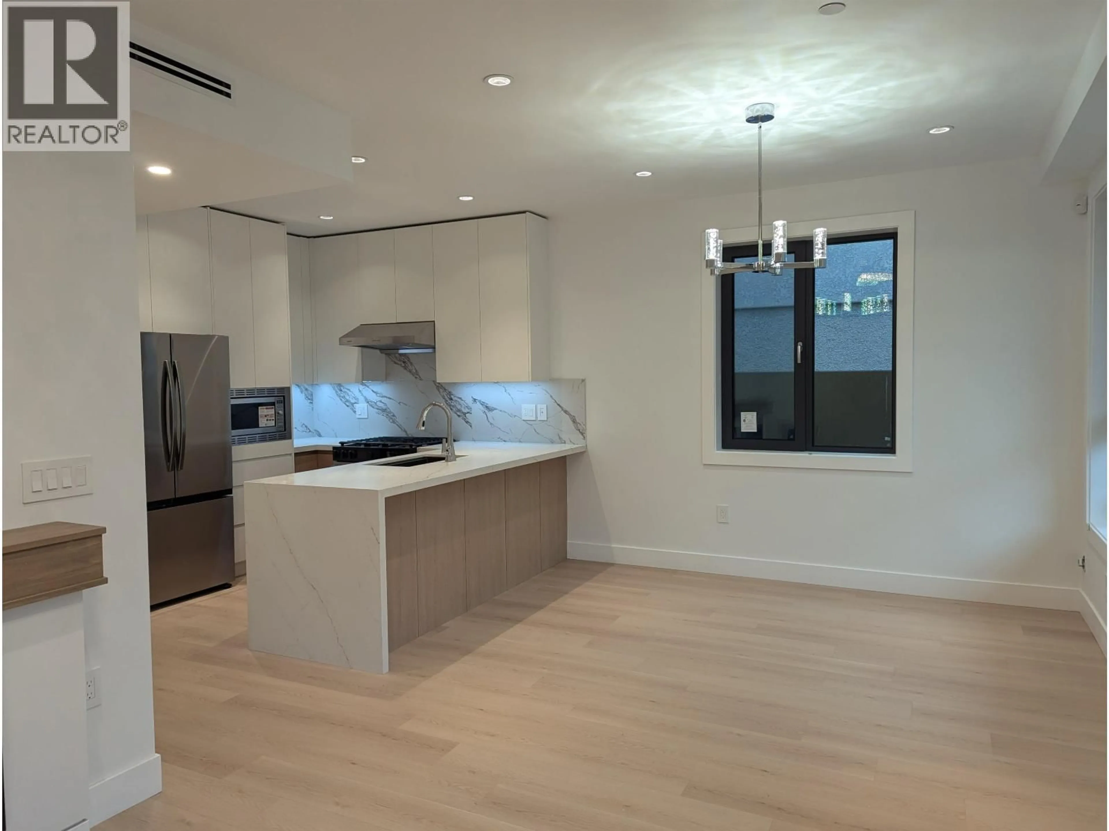 Open concept kitchen, wood/laminate floor for 2 - 262 65TH AVENUE, Vancouver British Columbia V5X2P4