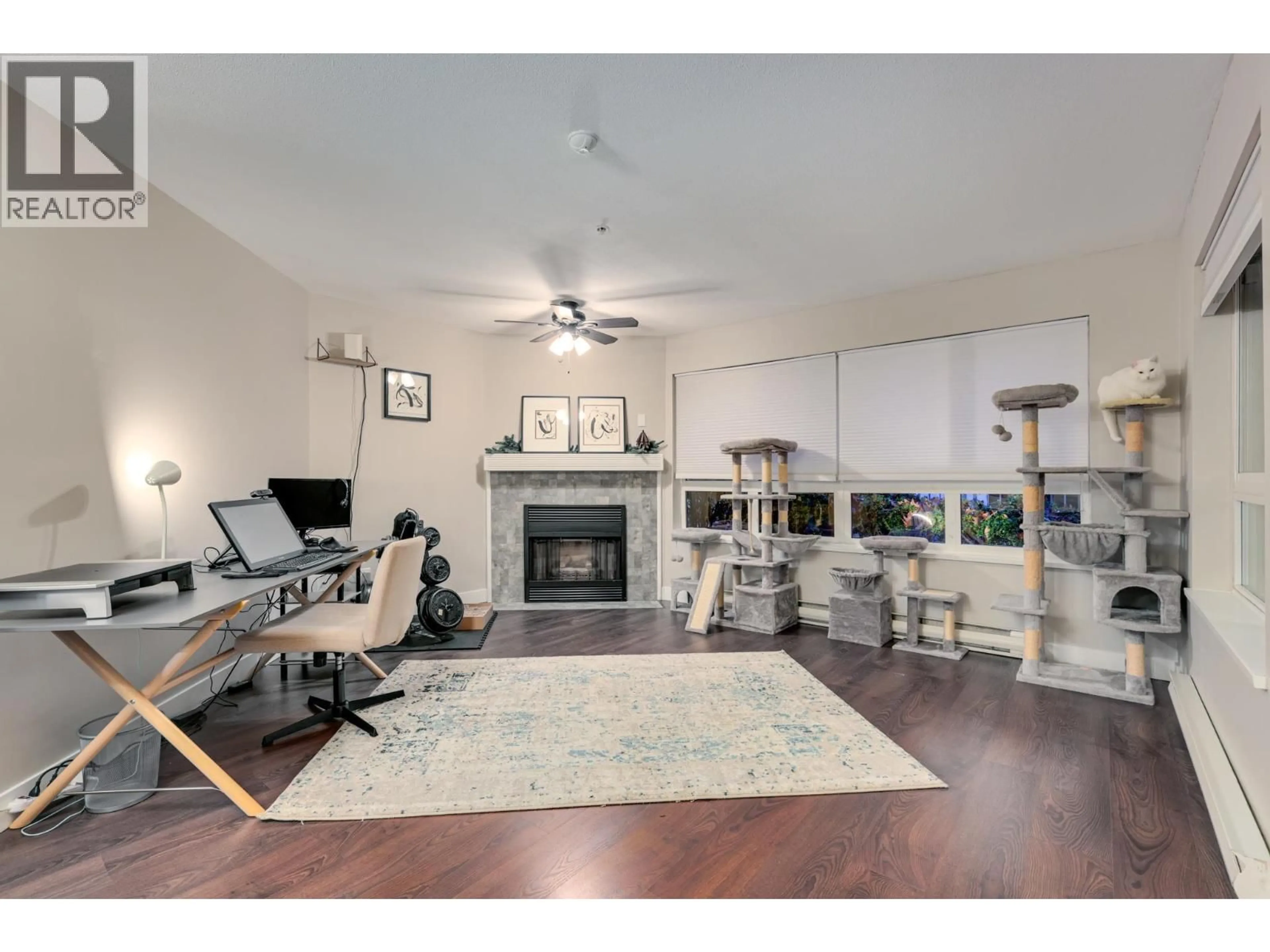 Living room with furniture, wood/laminate floor for 106 - 2439 WILSON AVENUE, Port Coquitlam British Columbia V3C6H6