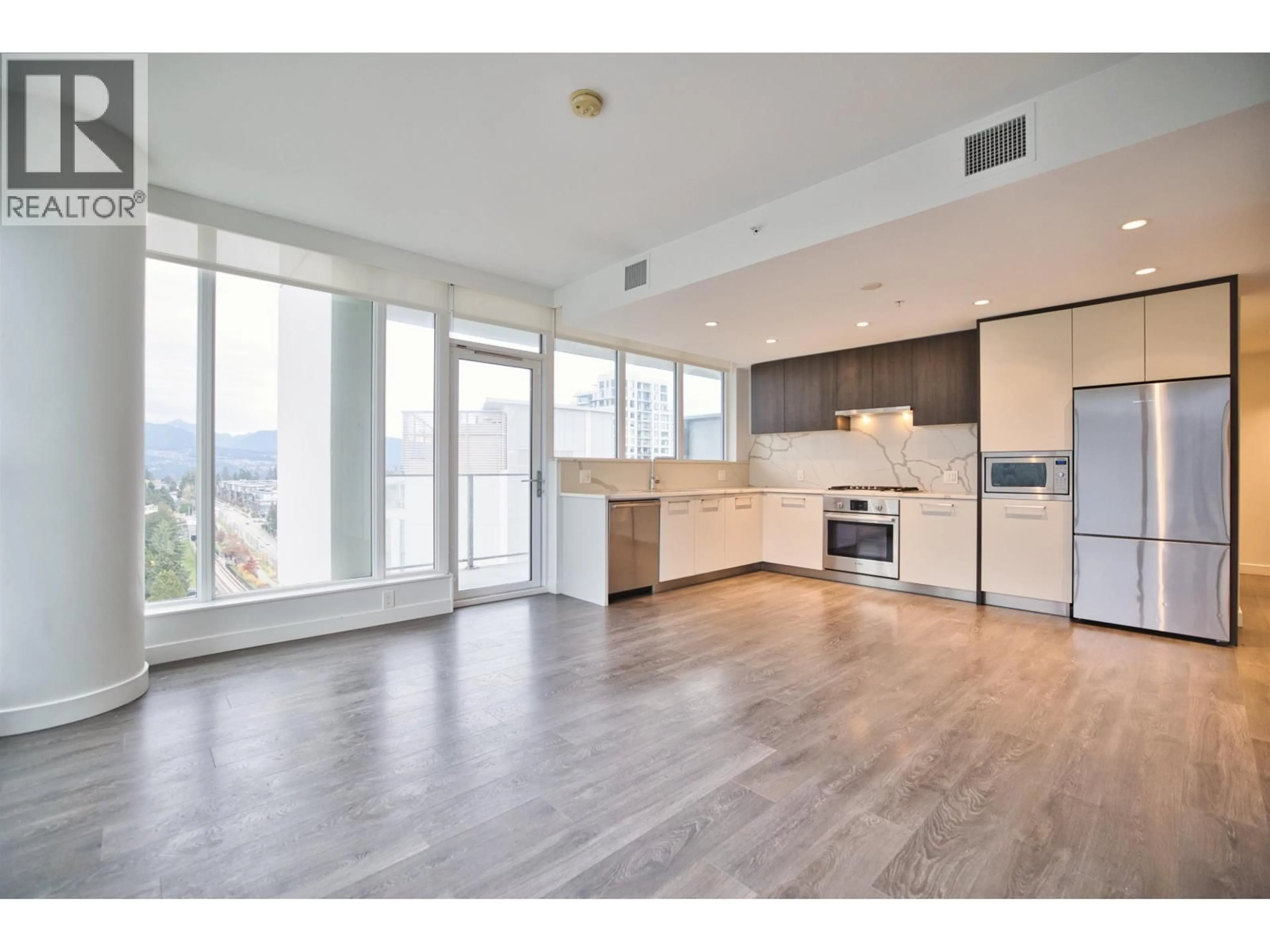 Open concept kitchen, wood/laminate floor for 1604 - 567 CLARKE ROAD, Coquitlam British Columbia V3J0K7