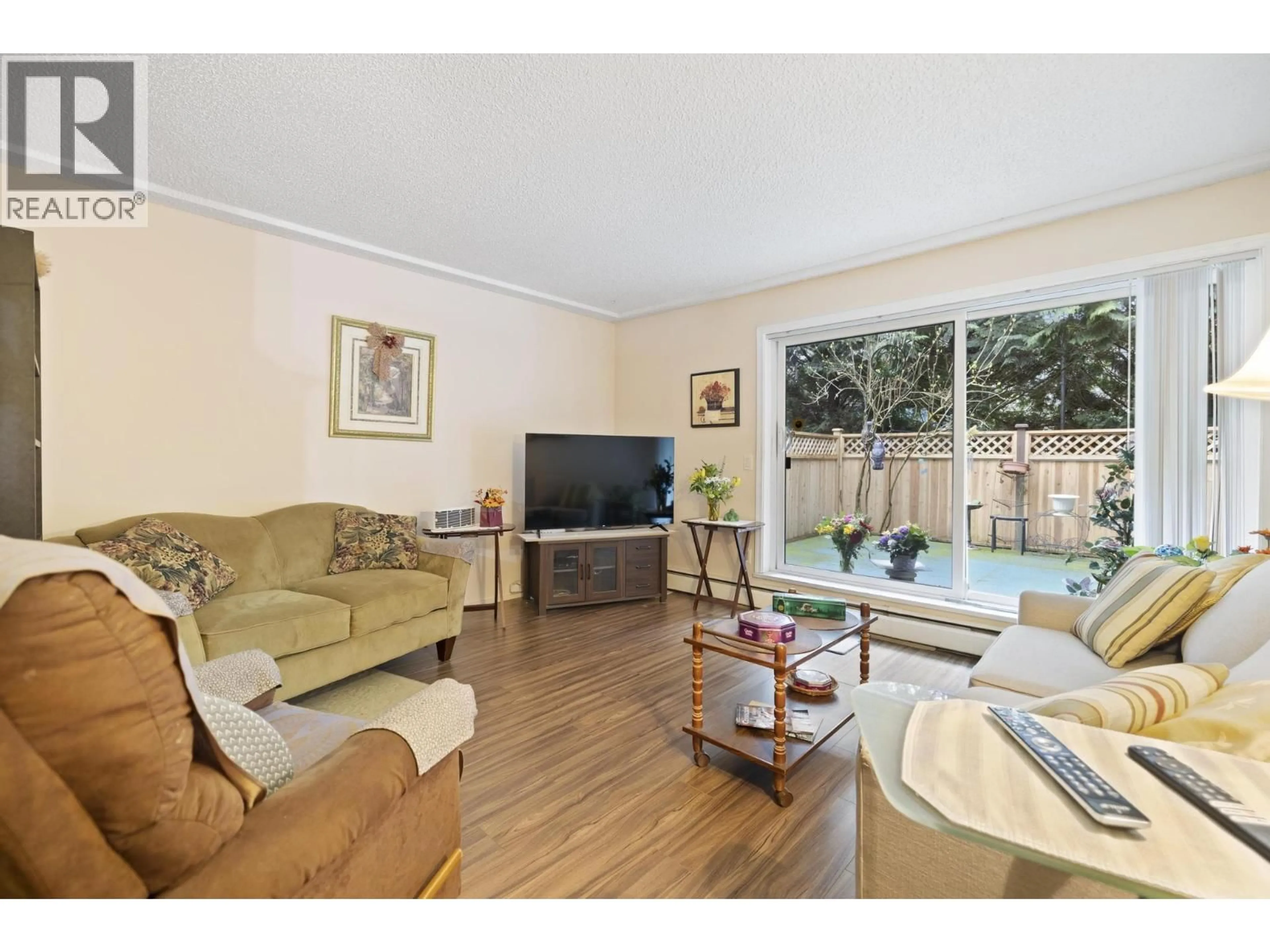 Living room with furniture, wood/laminate floor for 116 - 7240 LINDSAY ROAD, Richmond British Columbia V7C3M6