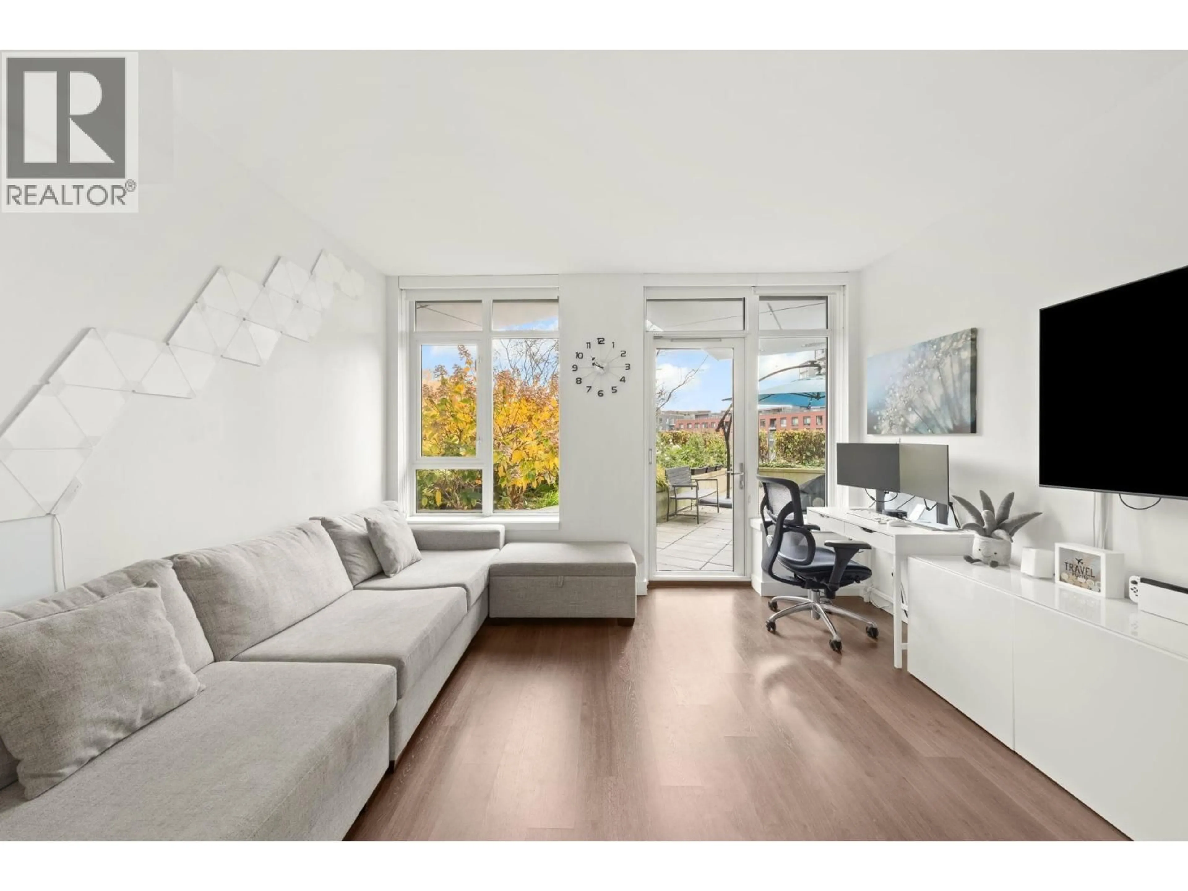 Living room with furniture, wood/laminate floor for 209 - 3557 SAWMILL CRESCENT, Vancouver British Columbia V5S0E2