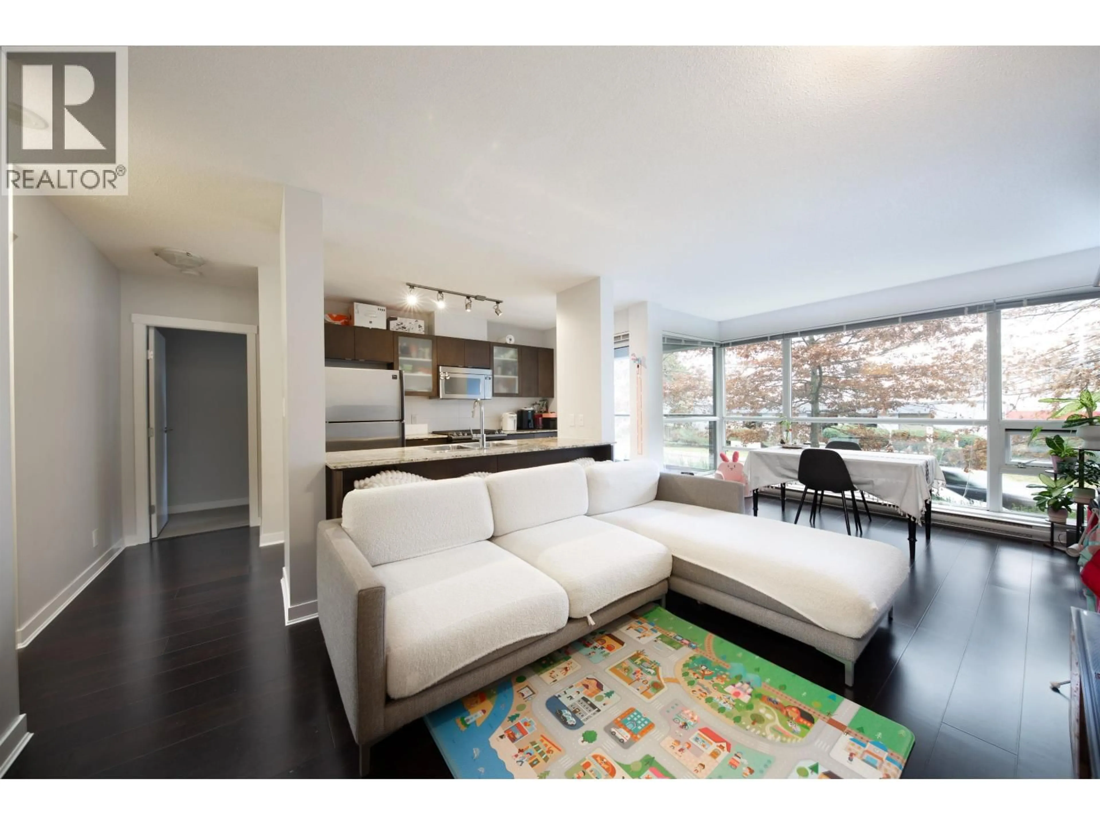 Living room with furniture, wood/laminate floor for 202 - 7535 ALDERBRIDGE WAY, Richmond British Columbia V6X4L2