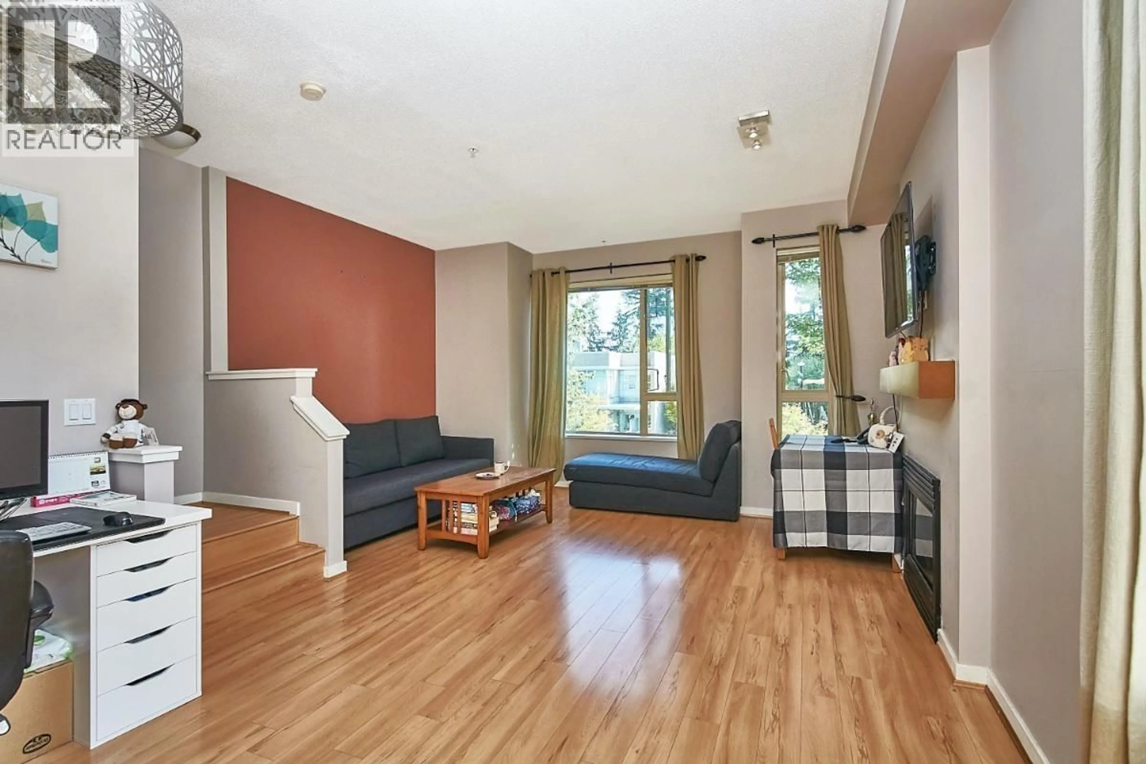 Living room with furniture, wood/laminate floor for 132 - 9229 UNIVERSITY CRESCENT, Burnaby British Columbia V5A4Z2