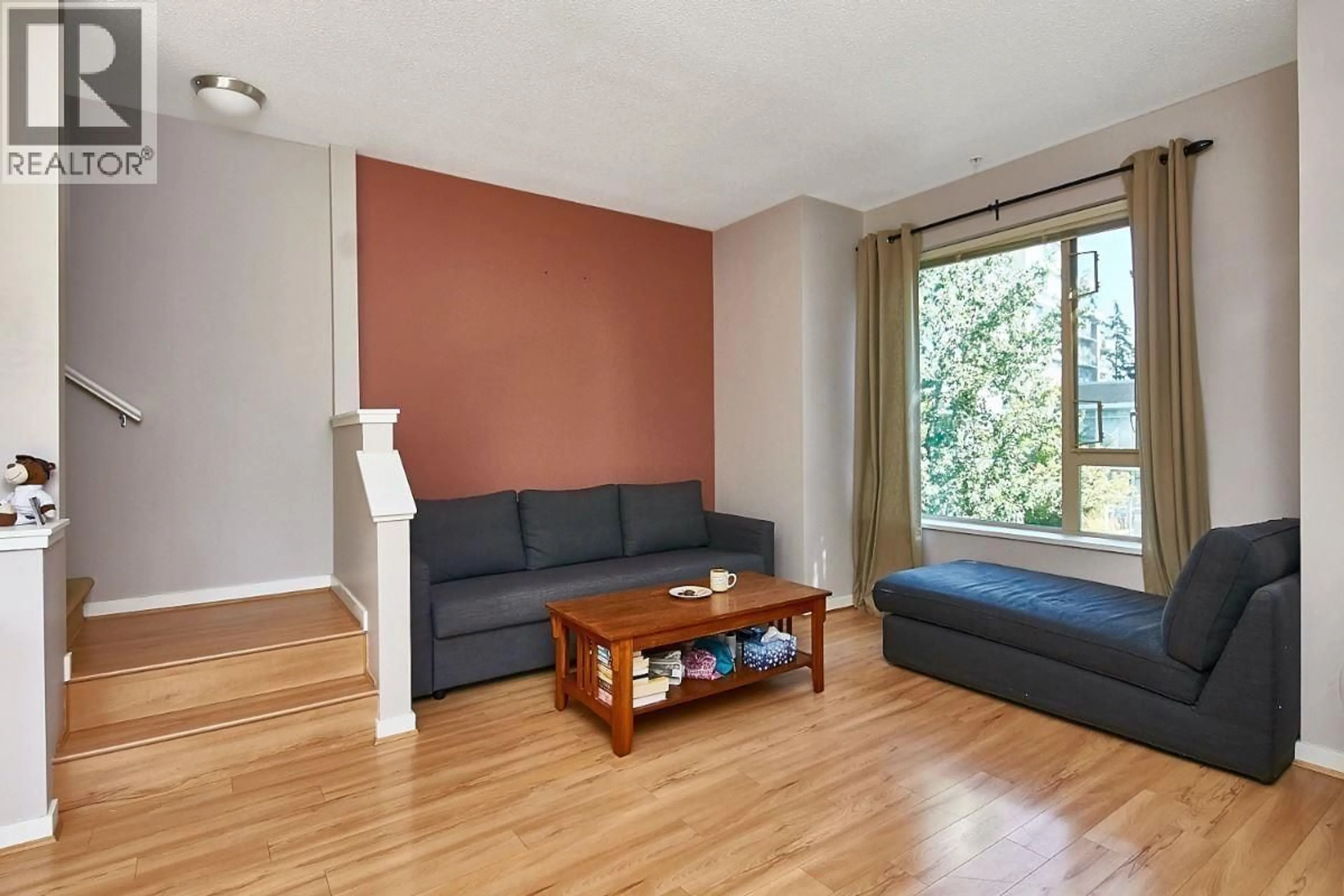 Living room with furniture, wood/laminate floor for 132 - 9229 UNIVERSITY CRESCENT, Burnaby British Columbia V5A4Z2