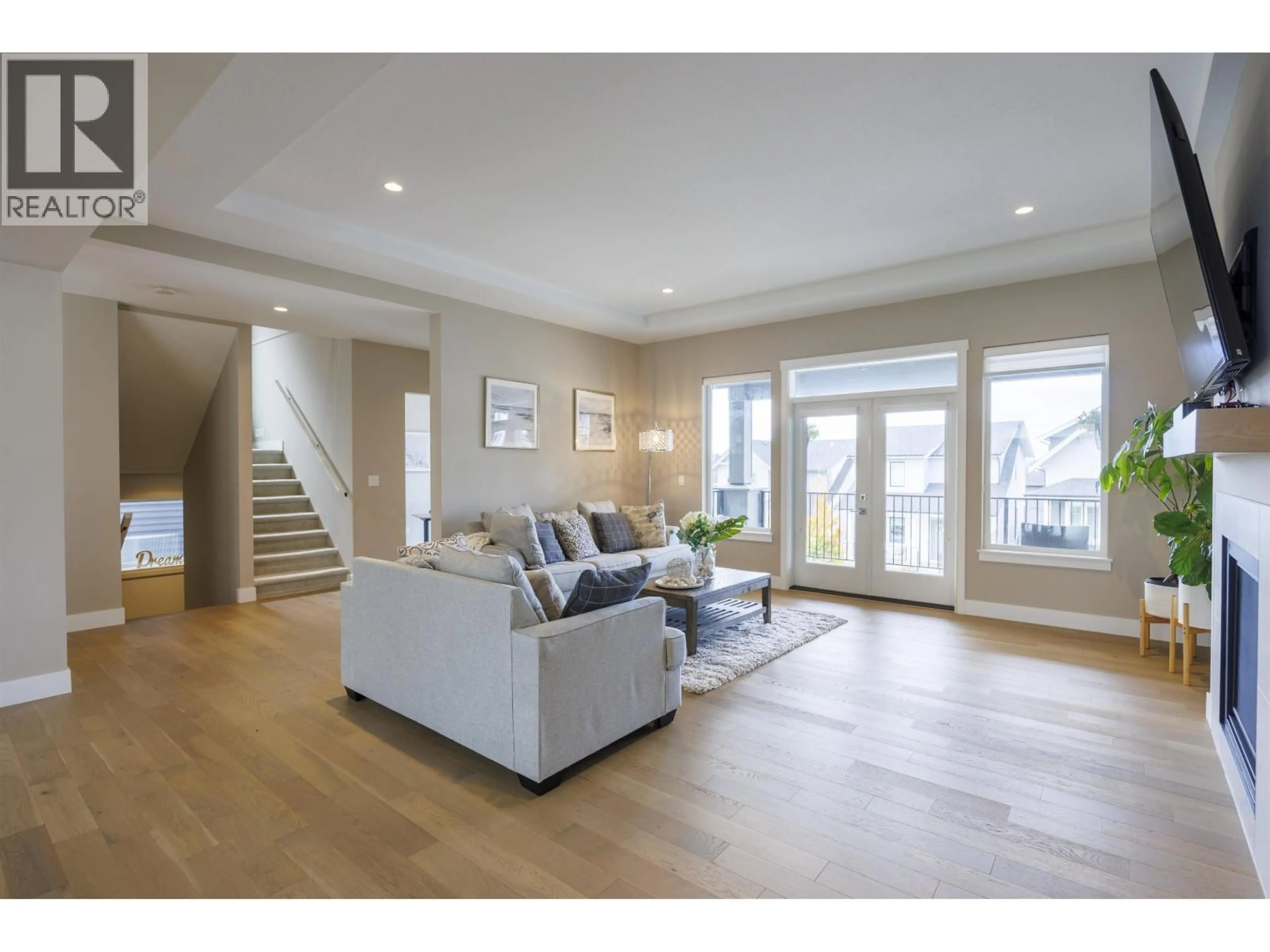 Living room with furniture, wood/laminate floor for 1441 NYSTROM COURT, Coquitlam British Columbia V3E0N5