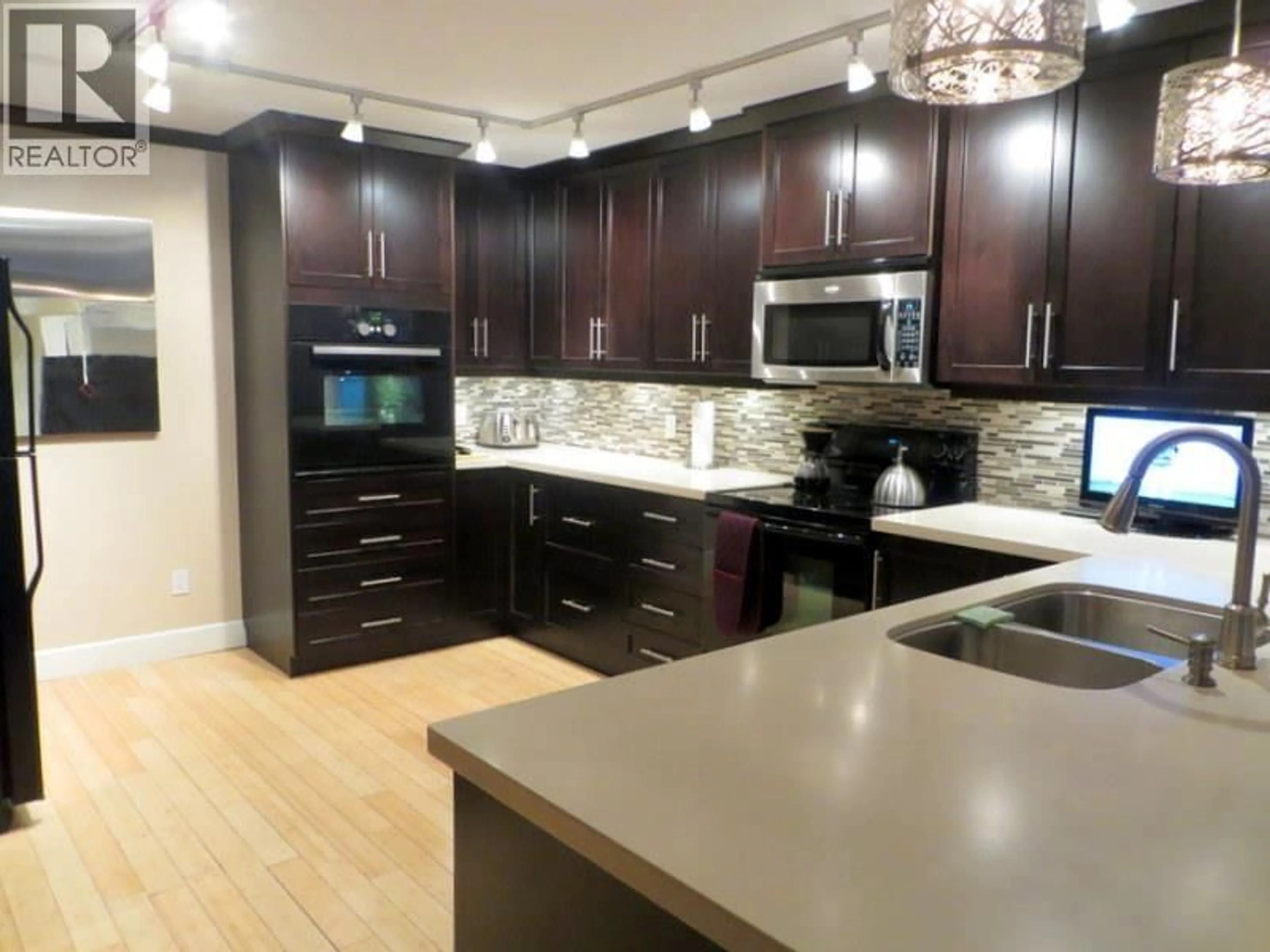 Open concept kitchen, wood/laminate floor for 203 - 4323 GALLANT AVENUE, North Vancouver British Columbia V7G2C1